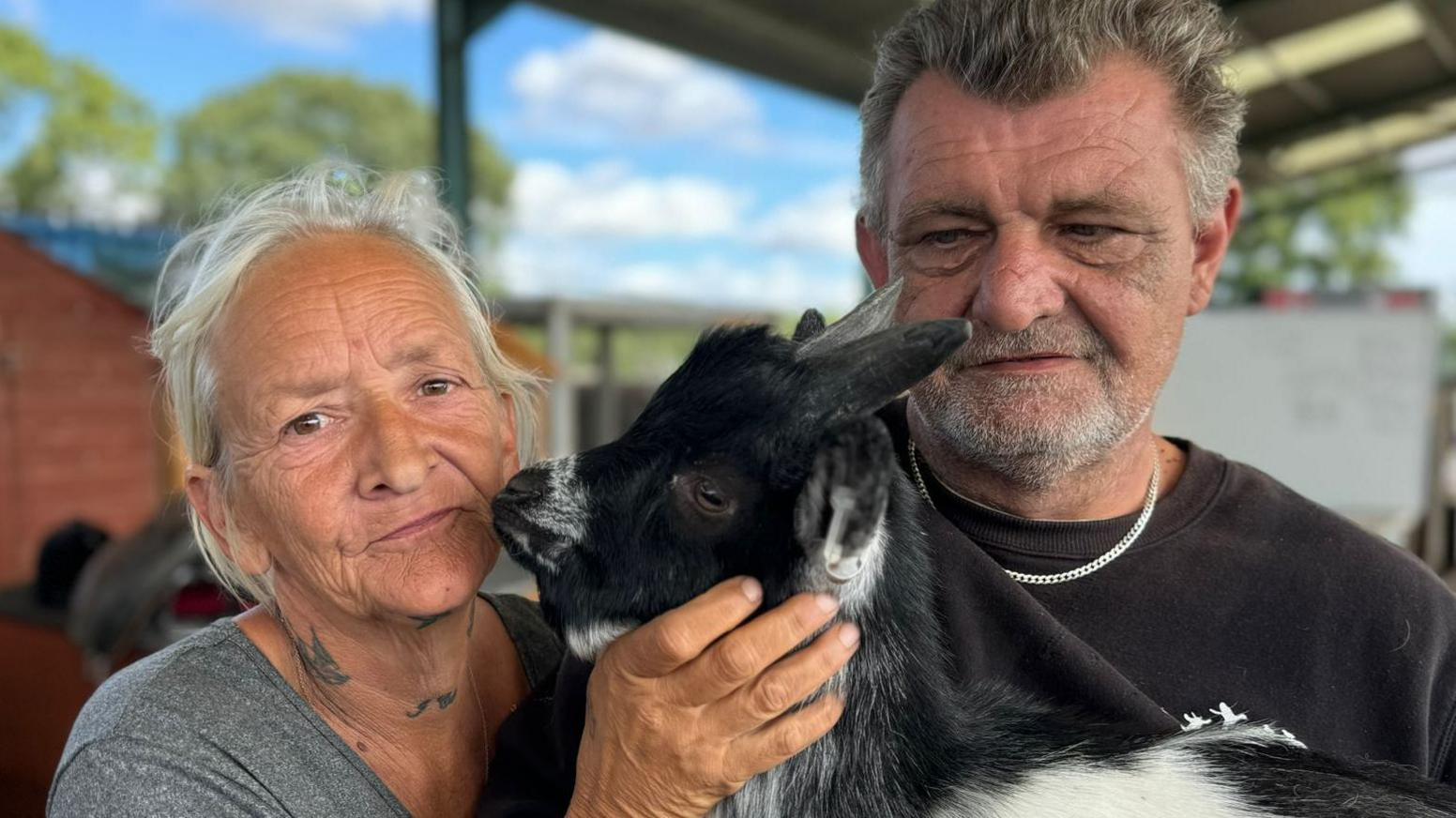 Sandy Miller and Gary Clarke with a goat at their farm in St Osyth