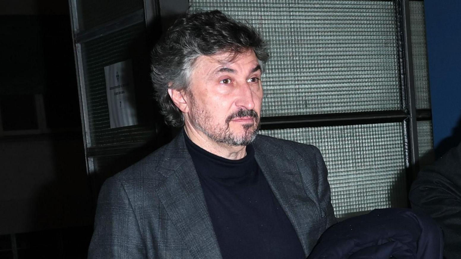 Watford owner Gino Pozzo, wearing a grey blazer and black sweatshirt, walks into the Giuseppe Sinigaglia Stadium before a game between Como 1907 and Udinese in January 2025