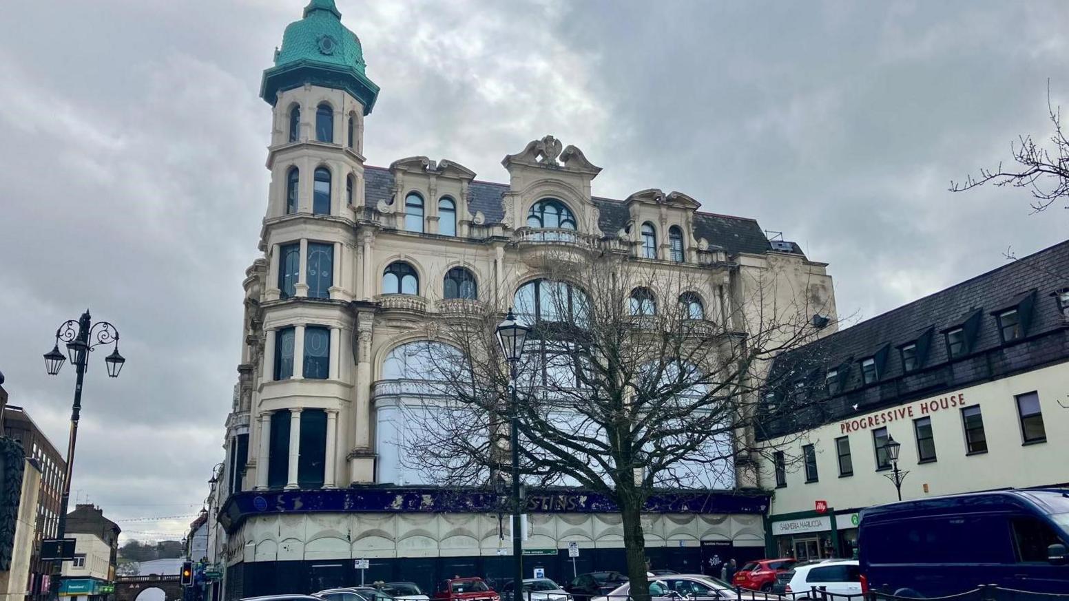 The grand Austins building in the diamond in Derry - in front of it is a tree with no leaves