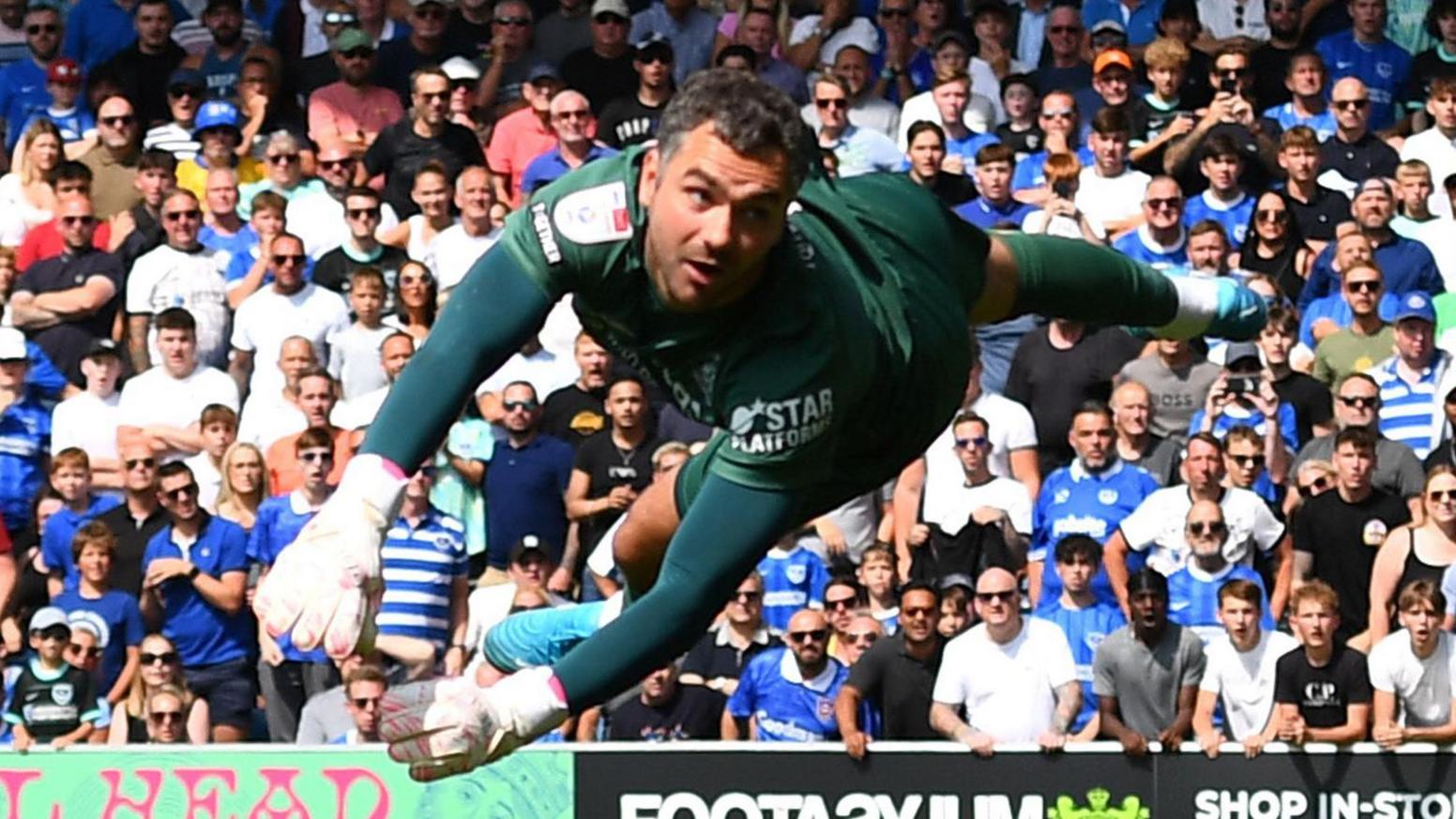 James Shea watches a Portsmouth shot fly wide of the post