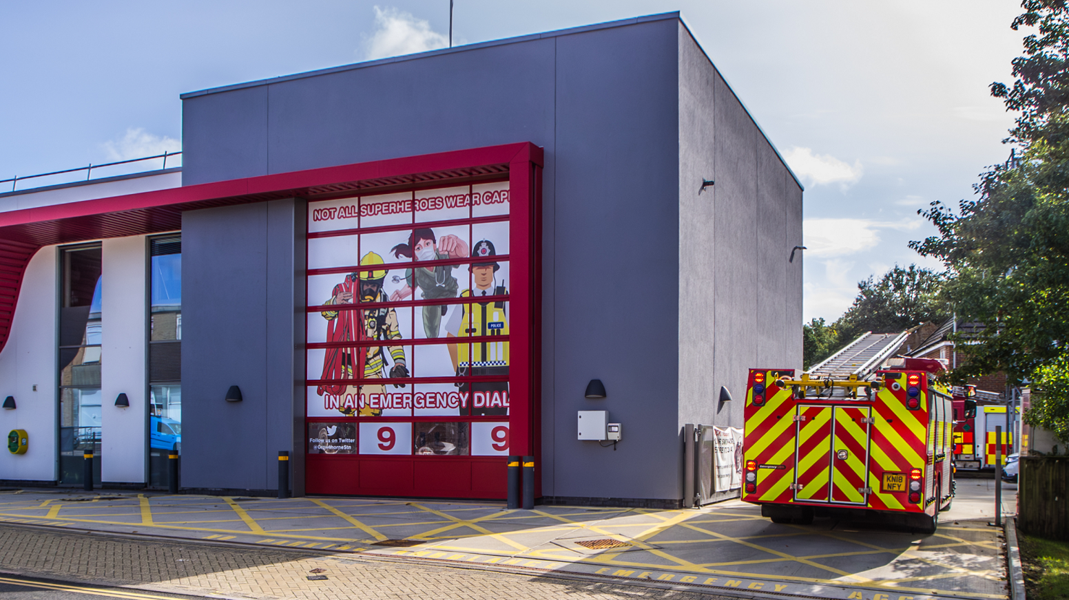 A general view of the Crowthorne fire station in Berkshire, with a fire engine to the right side of the station and a poster in the main window that says: "Not all superheroes wear capes. In an emergency dial 999".