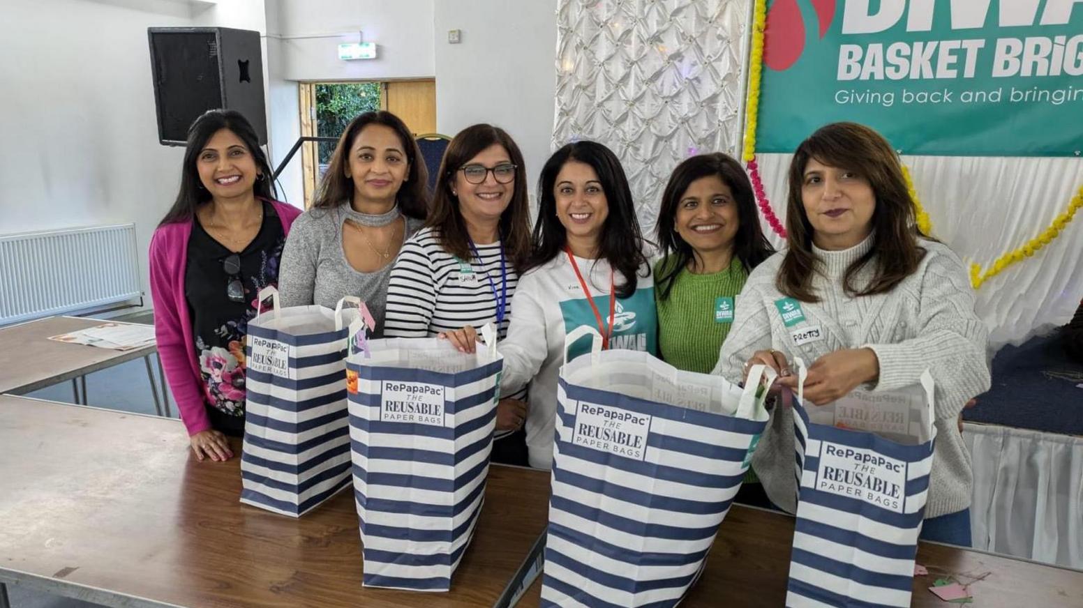 People at the Diwali Basket Bridgade packaging food hampers for donation.