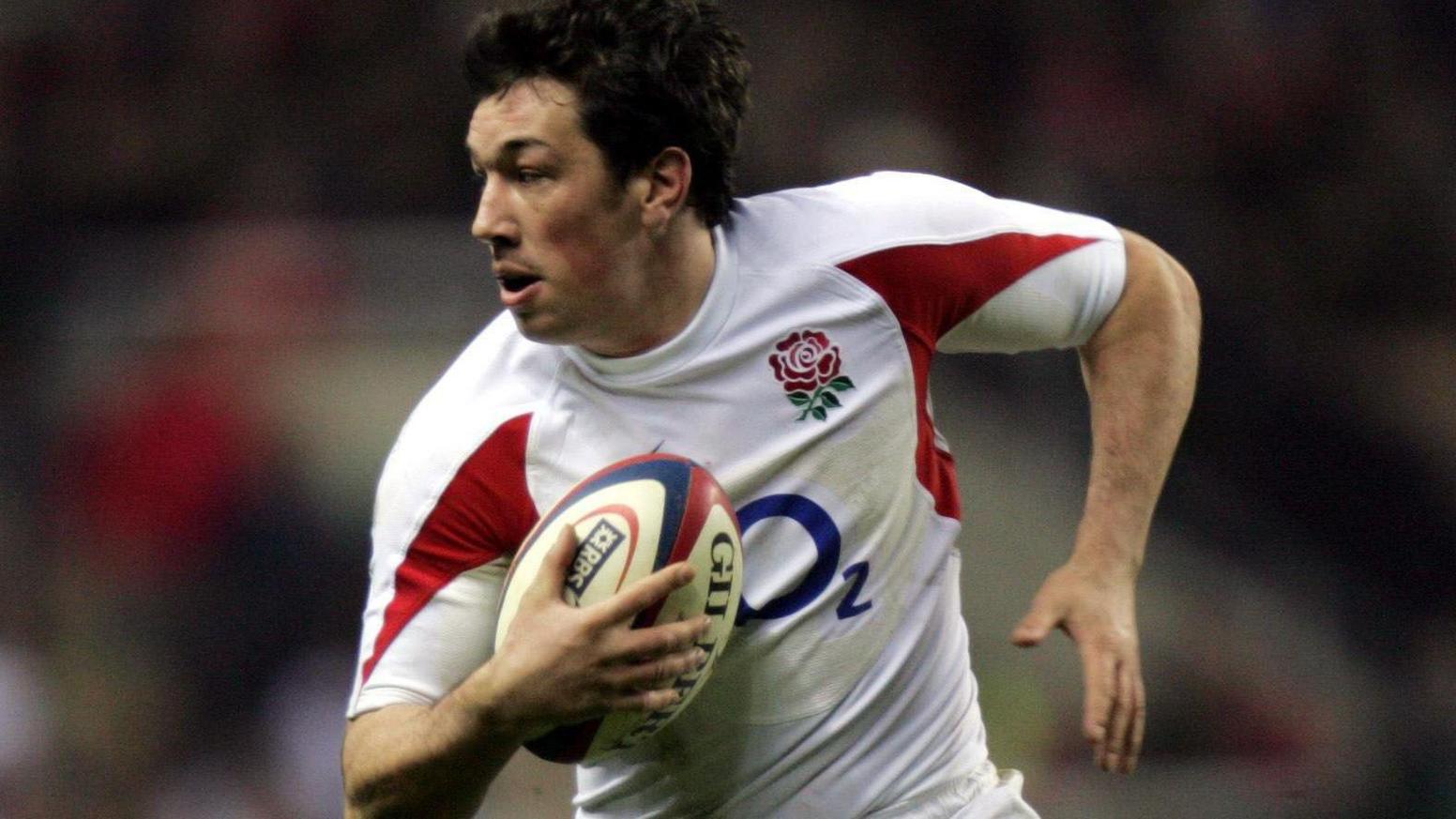 Tom Voyce playing rugby for England holding the ball.