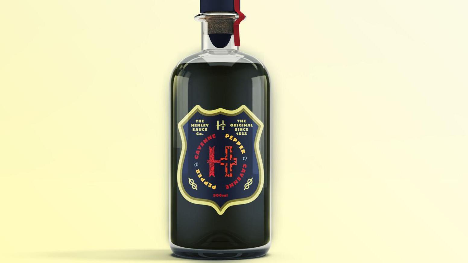 A glass bottle of black sauce with a Henley Sauce logo on the the label. The label has a dark blue background and text in yellow, red and blue.