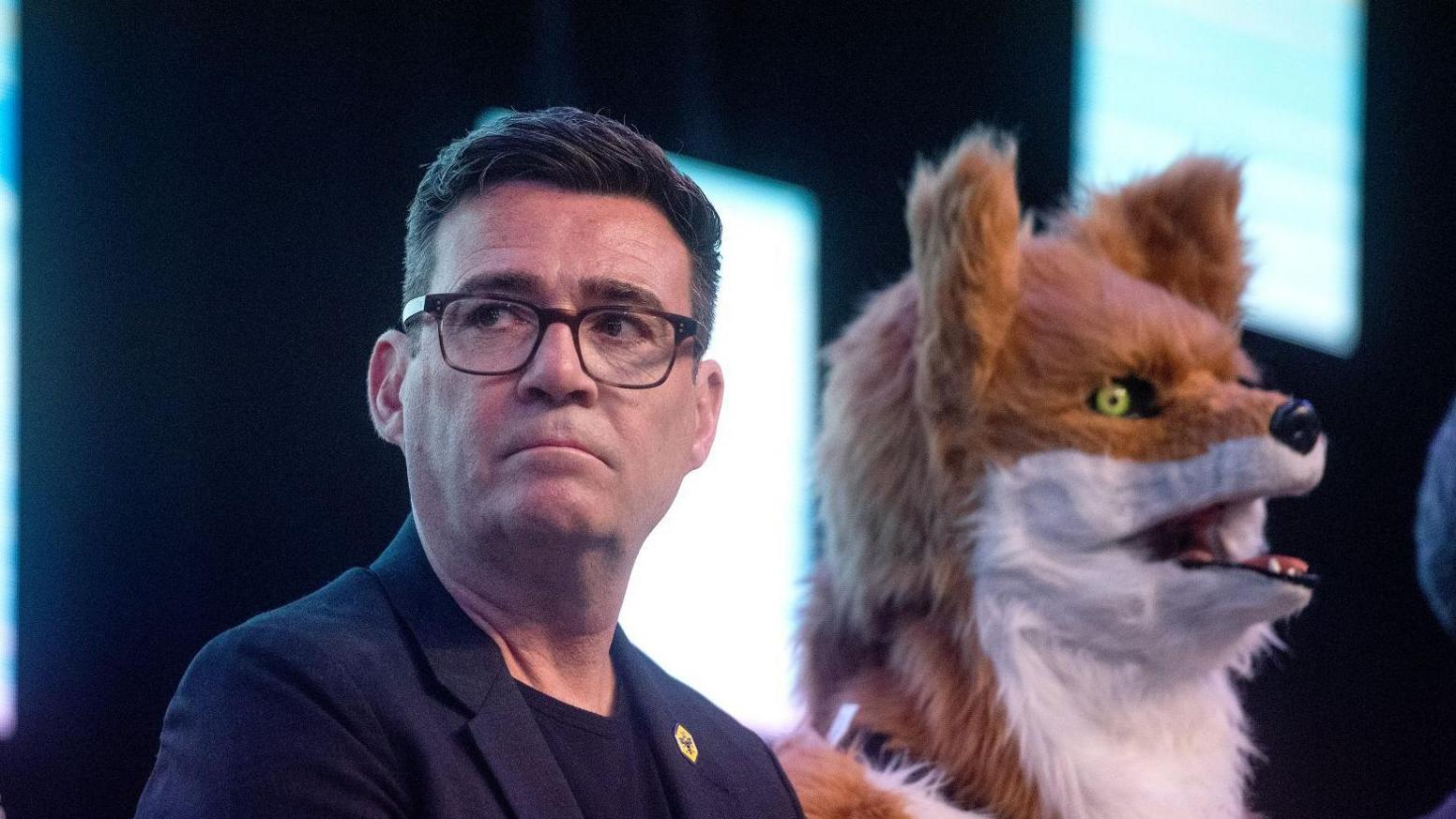 Andy Burnham between Count Binface and Rob Pownall who is dressed as a fox
