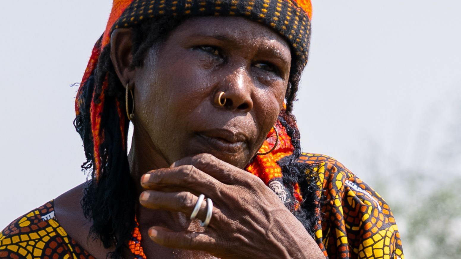 Aisha Isa stands near her plot in Darwa village.