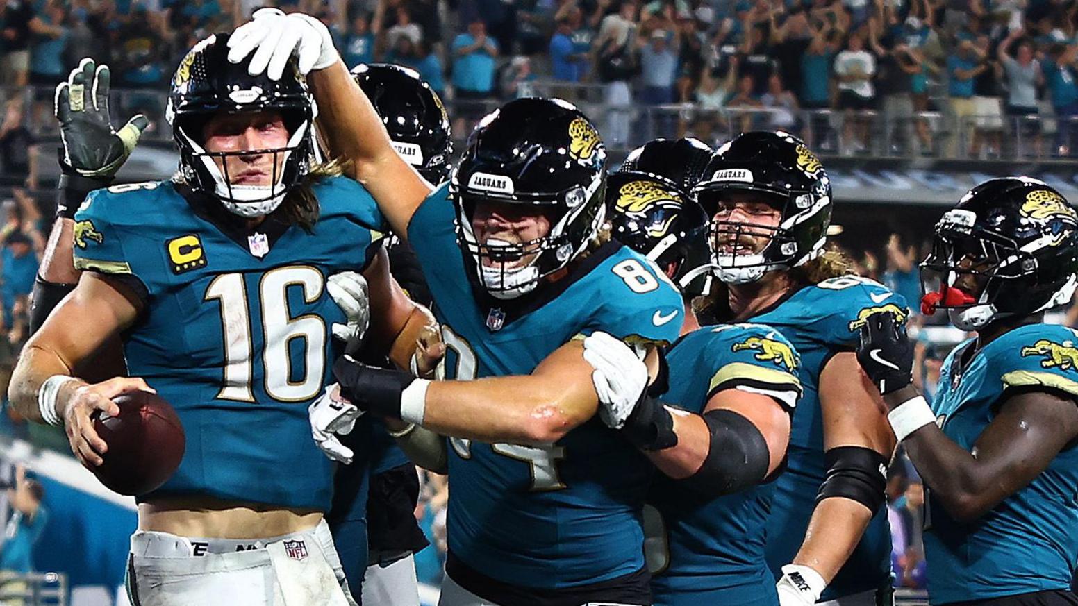 Jacksonville Jaguars quarterback Trevor Lawrence (left) is congratulated by team-mates against the Kansas City Chiefs