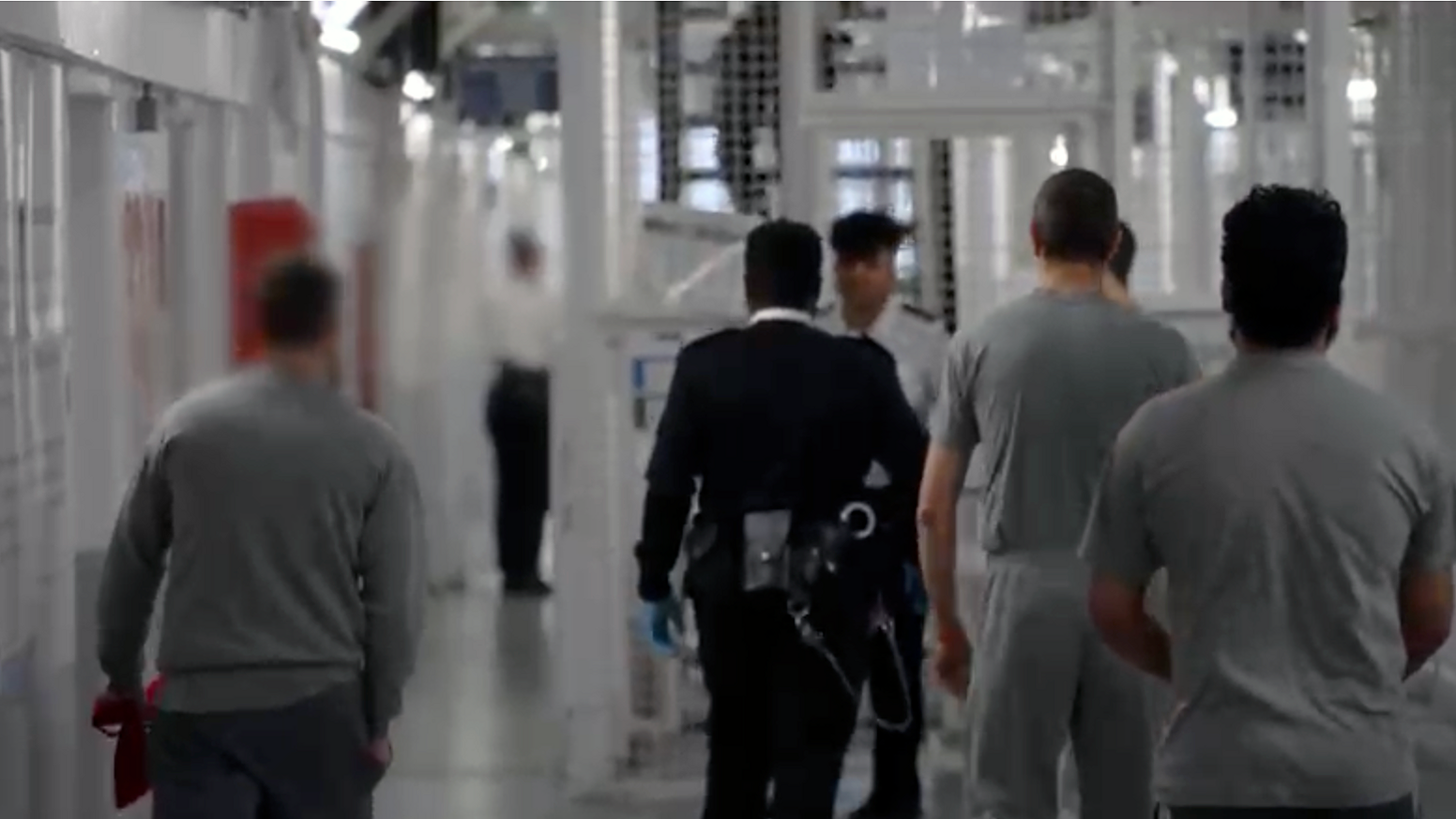 prison officers and prisoners walking around HMP Pentonville