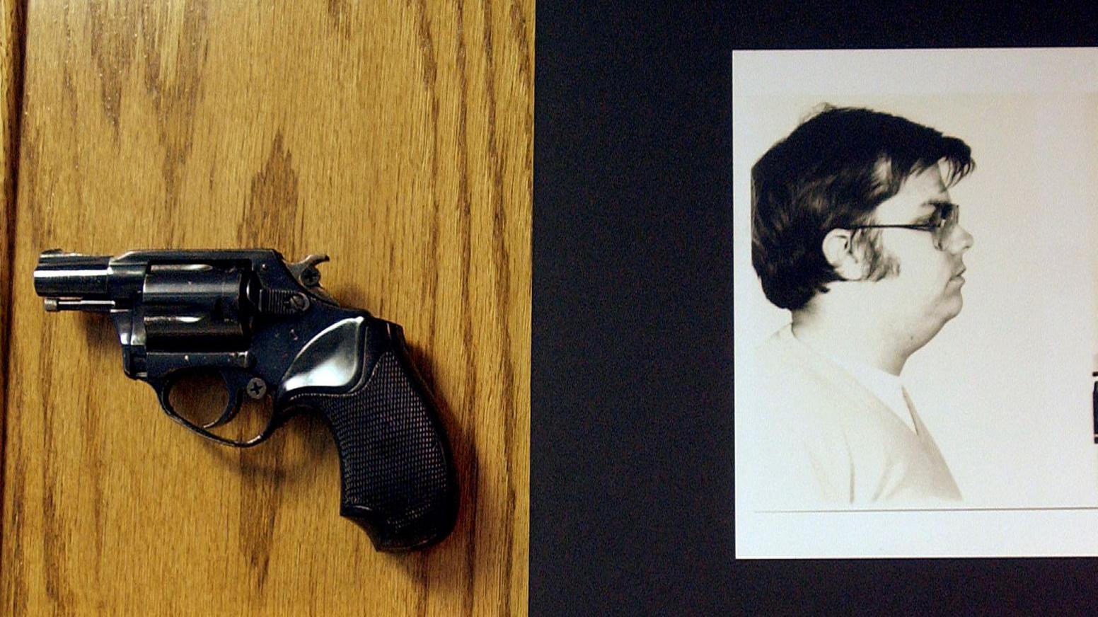 A .38 calibre handgun alongside a picture of Mark Chapman