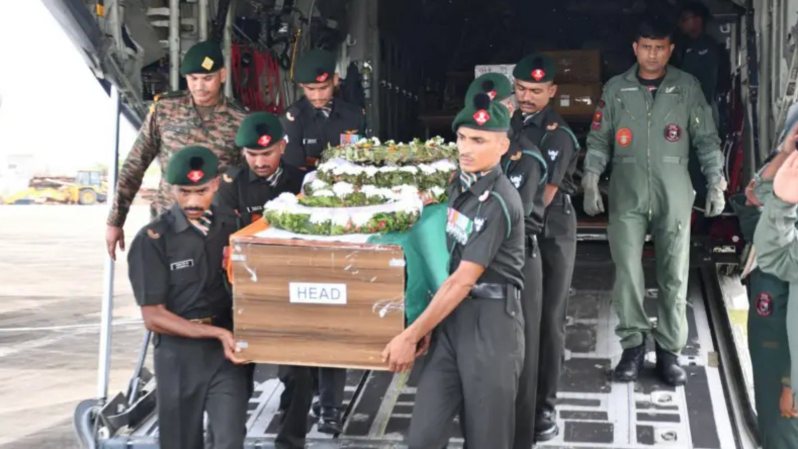 Indian army soldiers carry a casket with Cherian Thomas' body