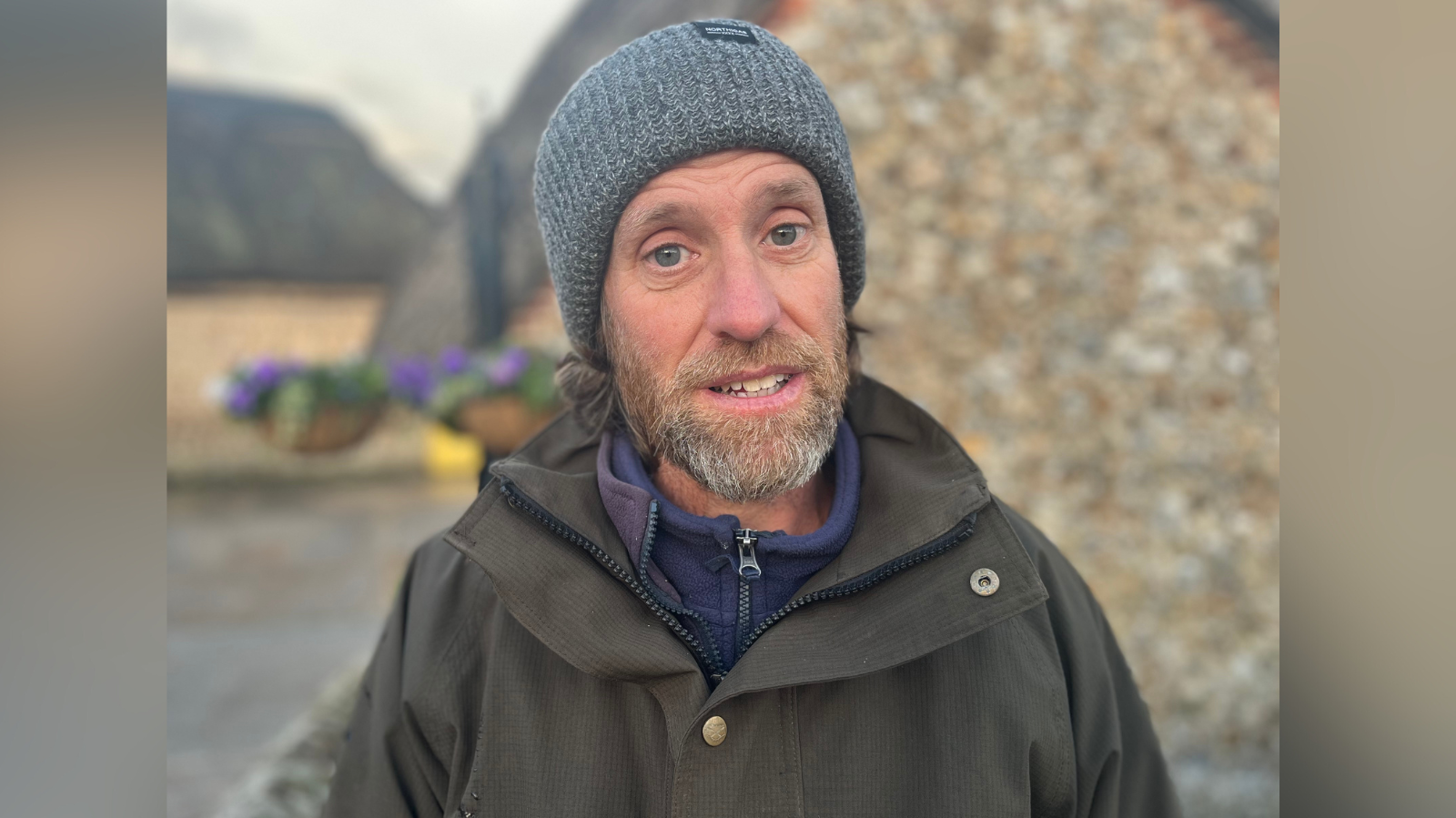 Jon Coker, a resident who was evacuated after a car crashed into a gas substation in Pagham Road, new Nyetimber, West Sussex. Jon is wearing a grey hat and a khaki coat. He has long hair and a graying beard.