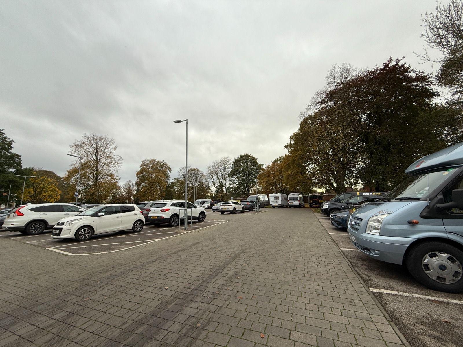 Vehicles, including cars and caravans, parked at The Lawn car park in Lincoln