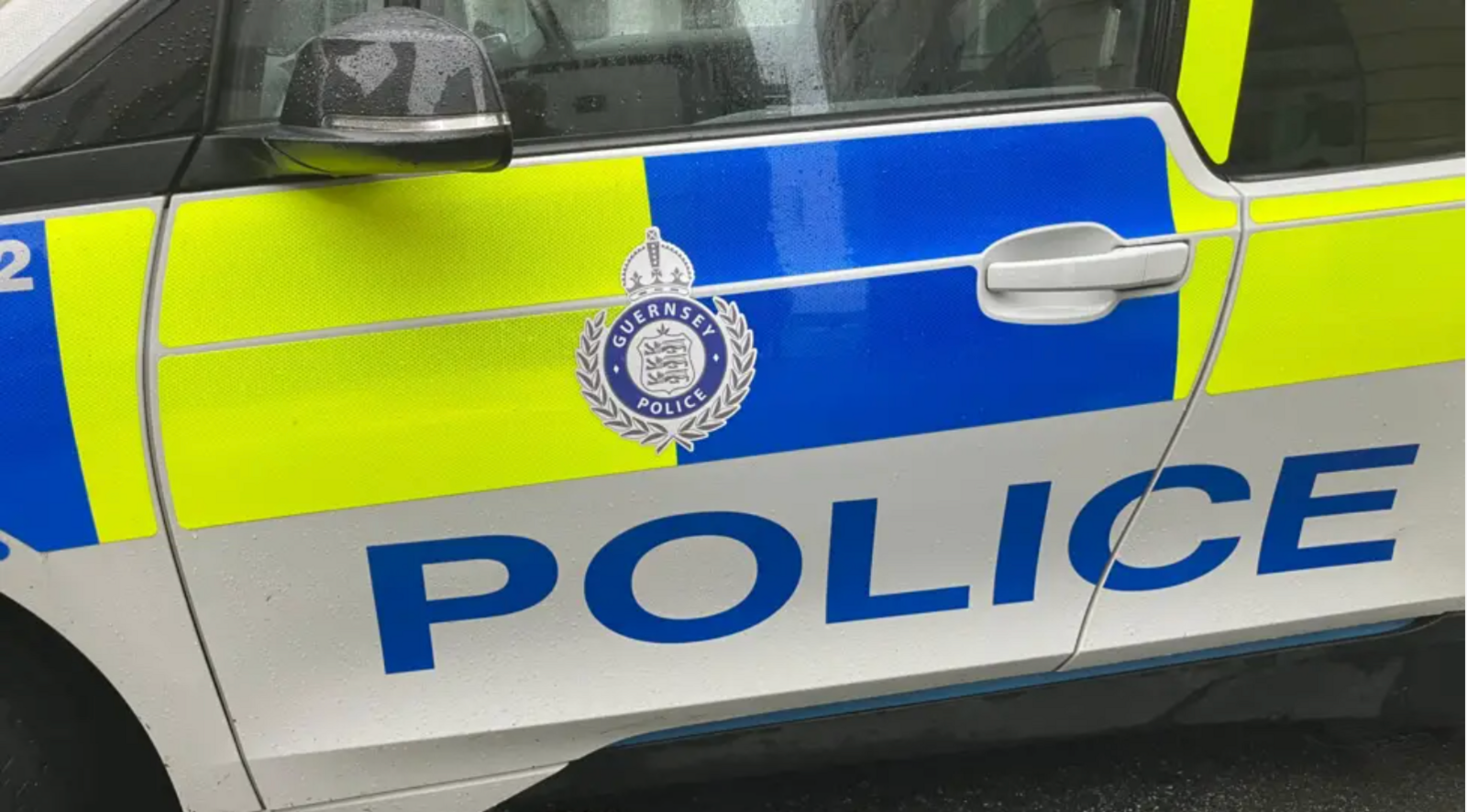 A police car with white, yellow and blue colours and a logo saying Guernsey Police and Police.