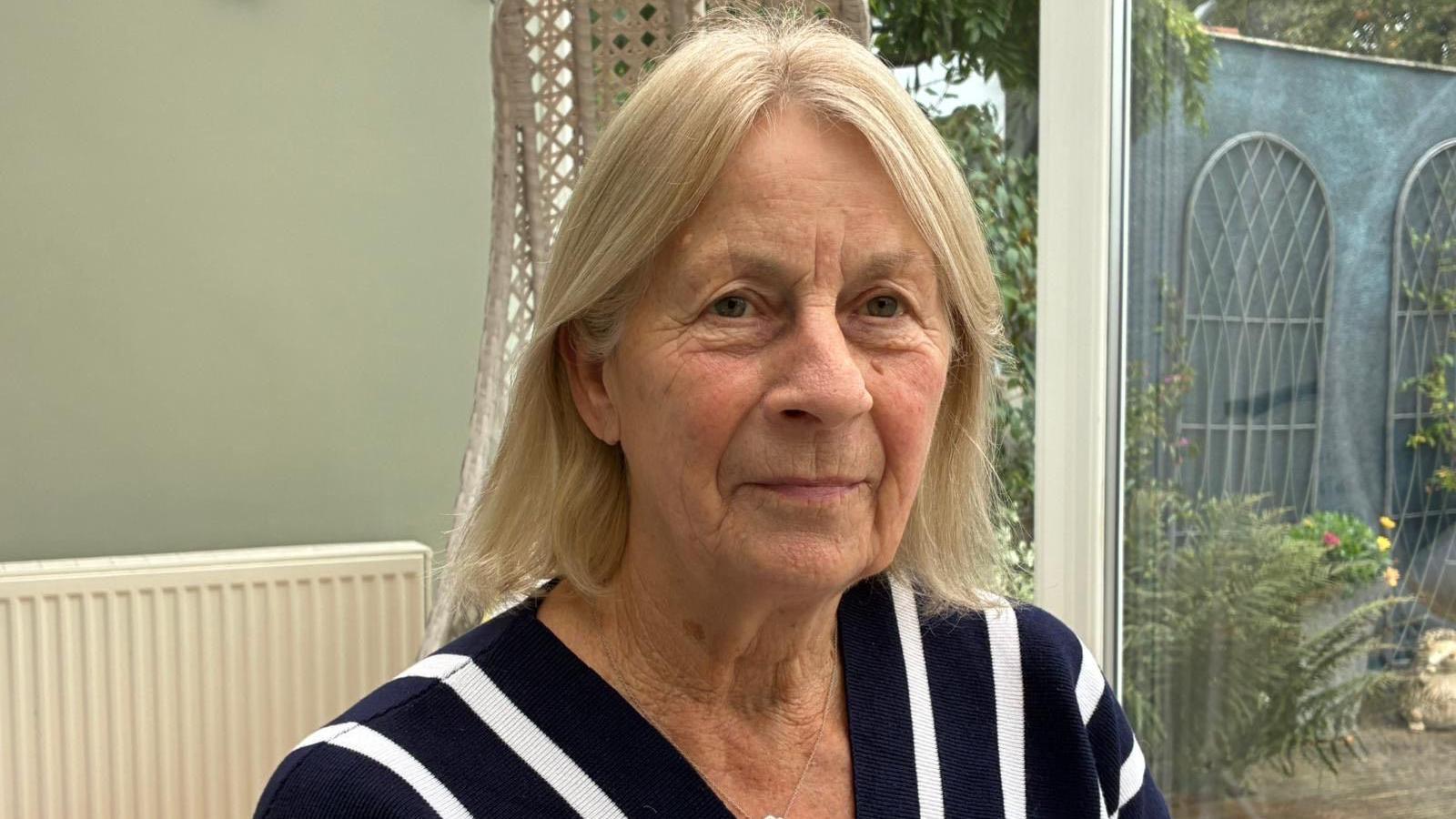 Image of Wanda in her conservatory.