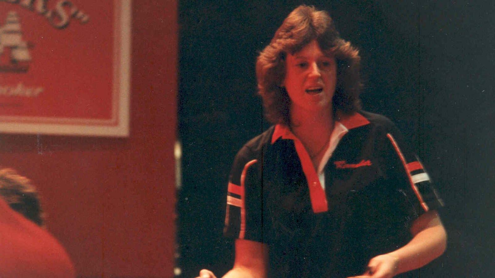 Dr Linda Duffy at a darts tournament in 1984, wearing a dark polo shirt