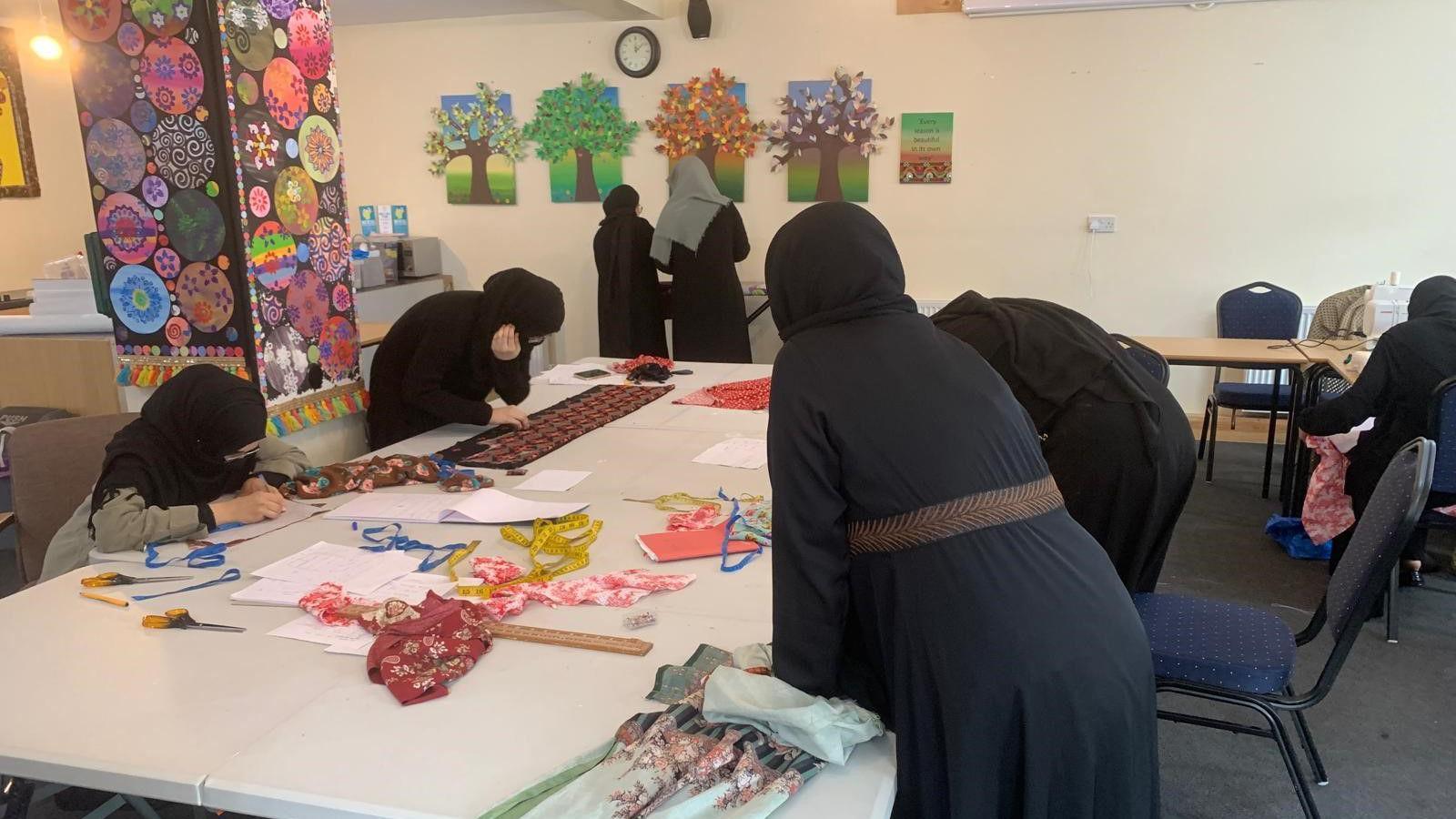 Women wearing headscarves taking part in the sewing classes 