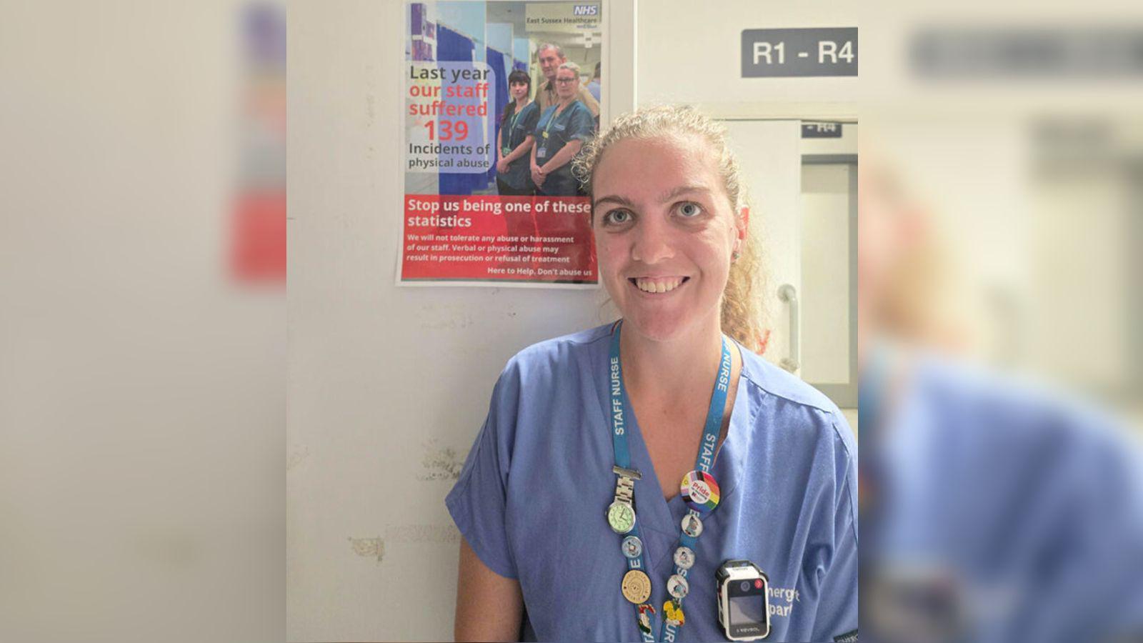 A nurse wears a body-worn camera on her overalls.