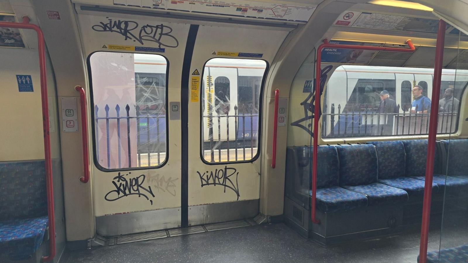 Graffiti seen on the inside of one of the Tube trains on the Central line