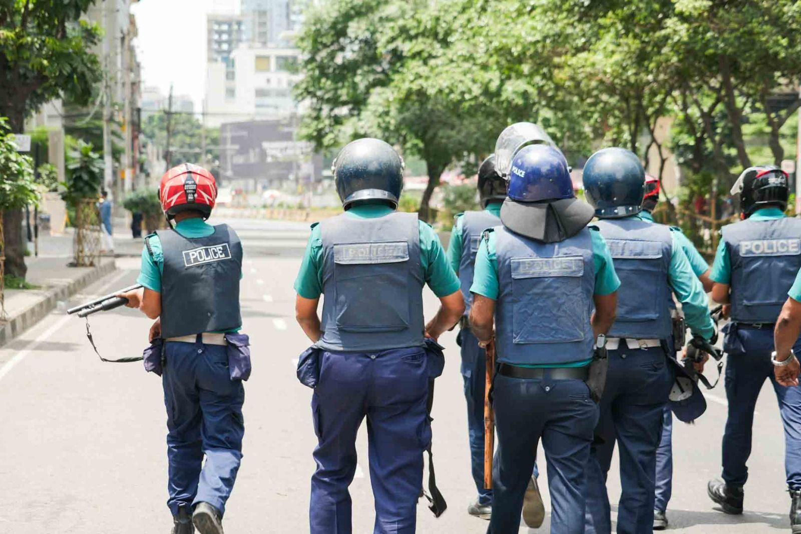 Police officers make their way down a street