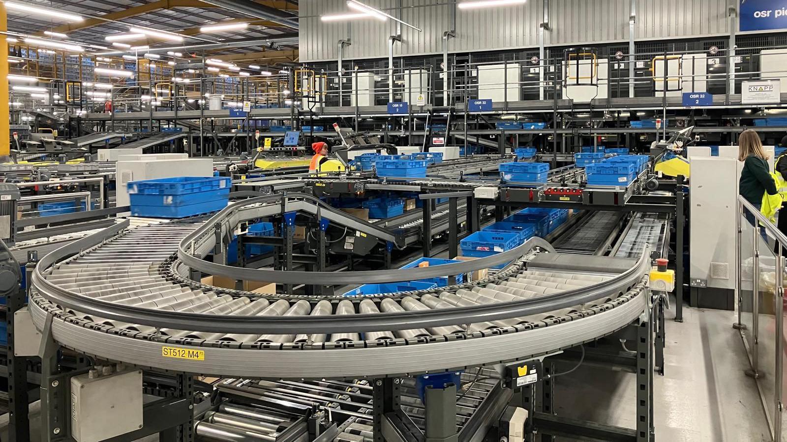 A production line at Boots factory with a number of blue containers on 