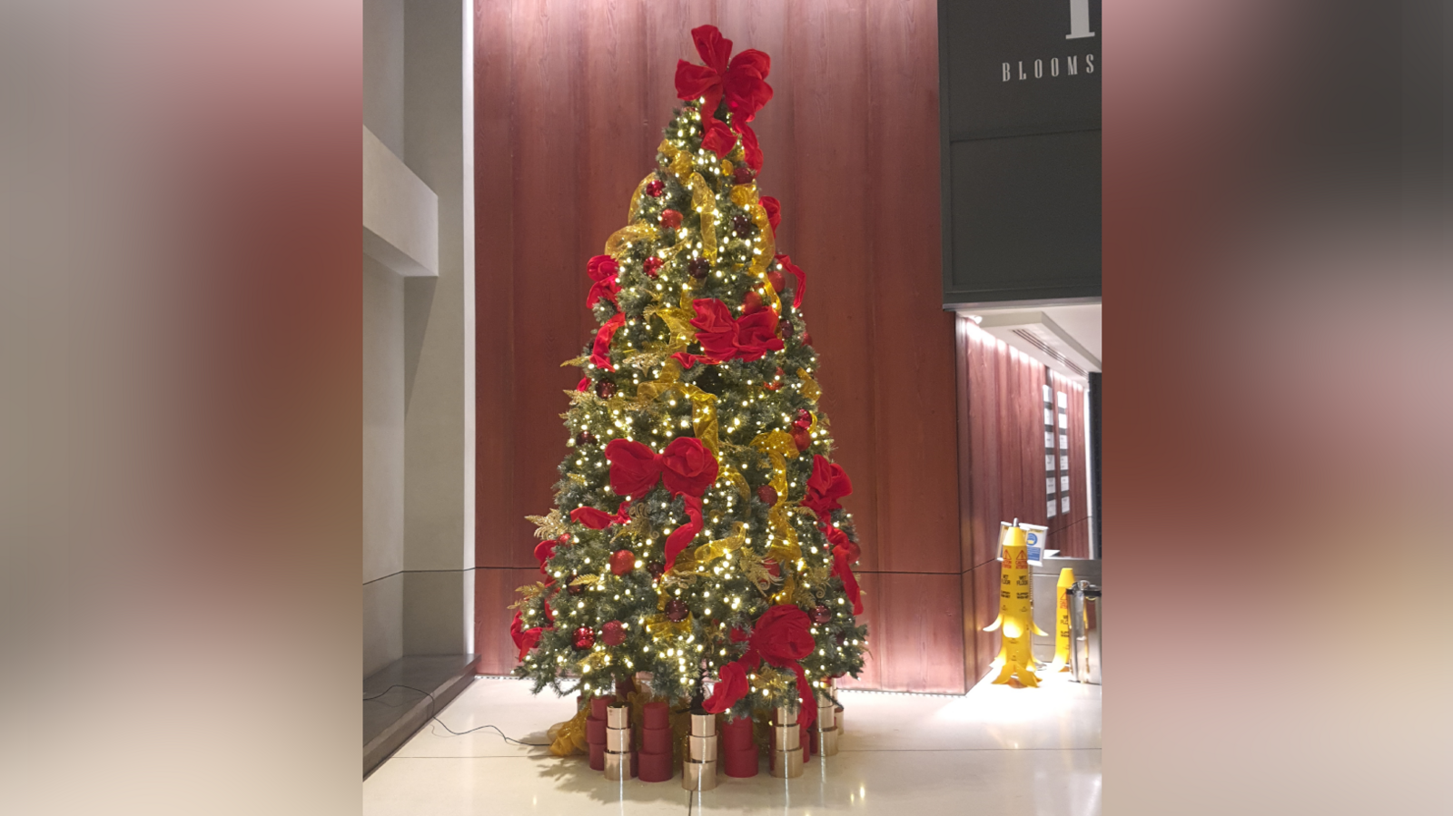 A large Christmas tree decorated with red and gold decorations