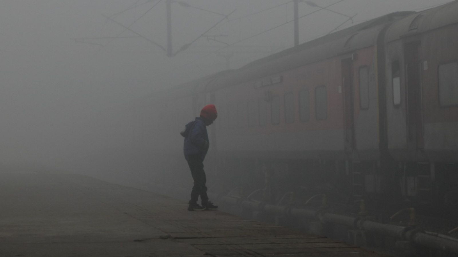 A child on a railway platform through dense smog as the temperature drops in Lucknow, India, on 23 January, 2024.