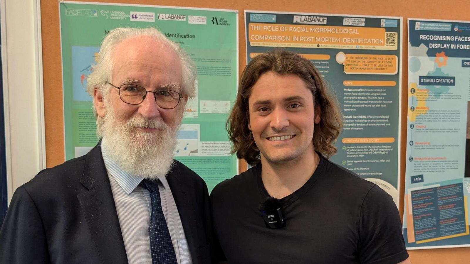 Prof David Crystal and actor Thomas Dennis in a university corridor