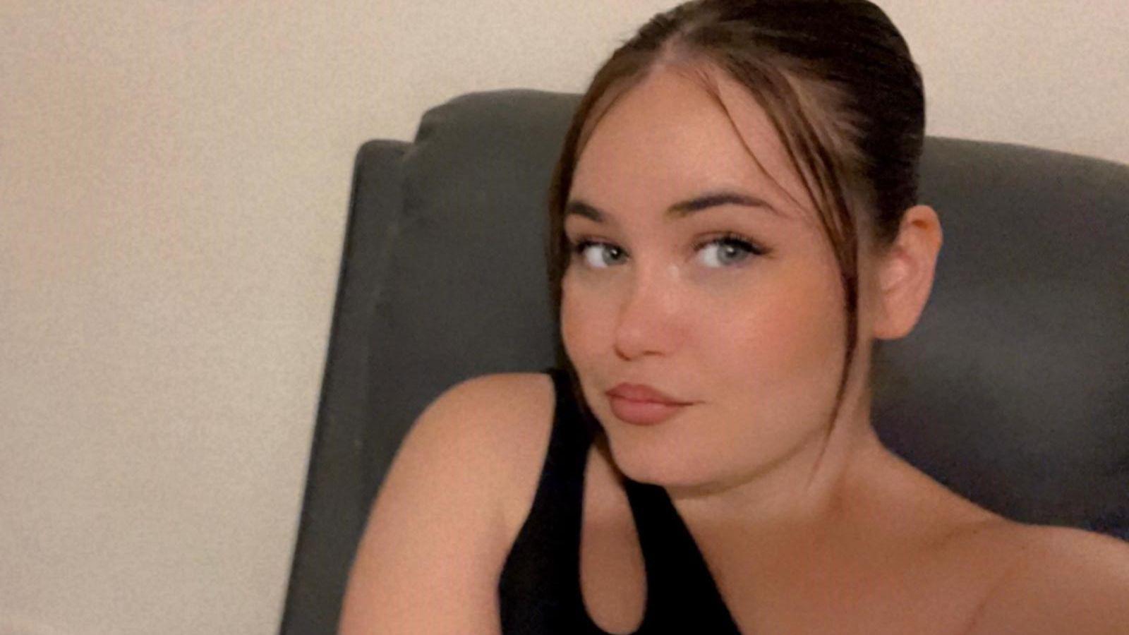 A selfie style image of Courtney Mitchell. She is wearing a black top and looking into the camera.