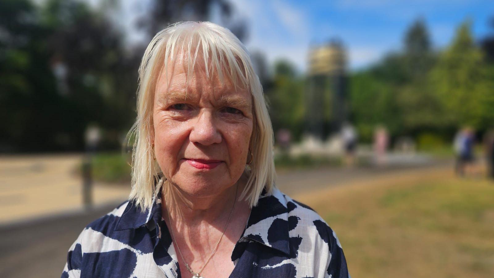 Charnwood borough councillor Anne Gray smiles at the camera she is wearing a blue and white shirt.
