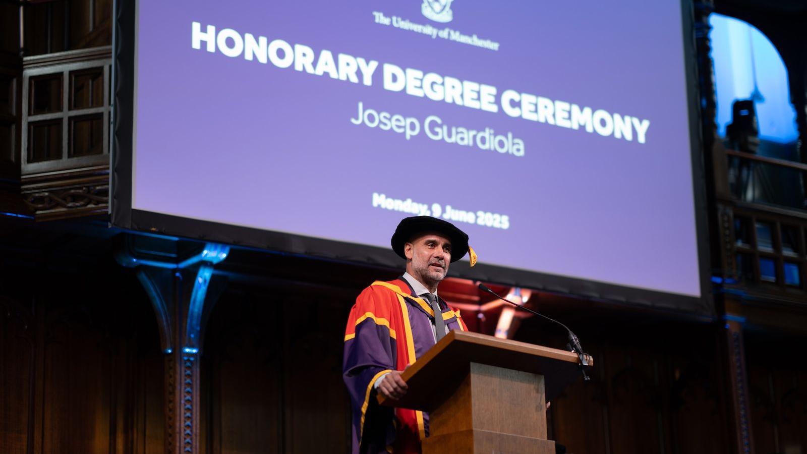 Pep Guardiola delivers a speech as he receives an honorary degree from the University of Manchester