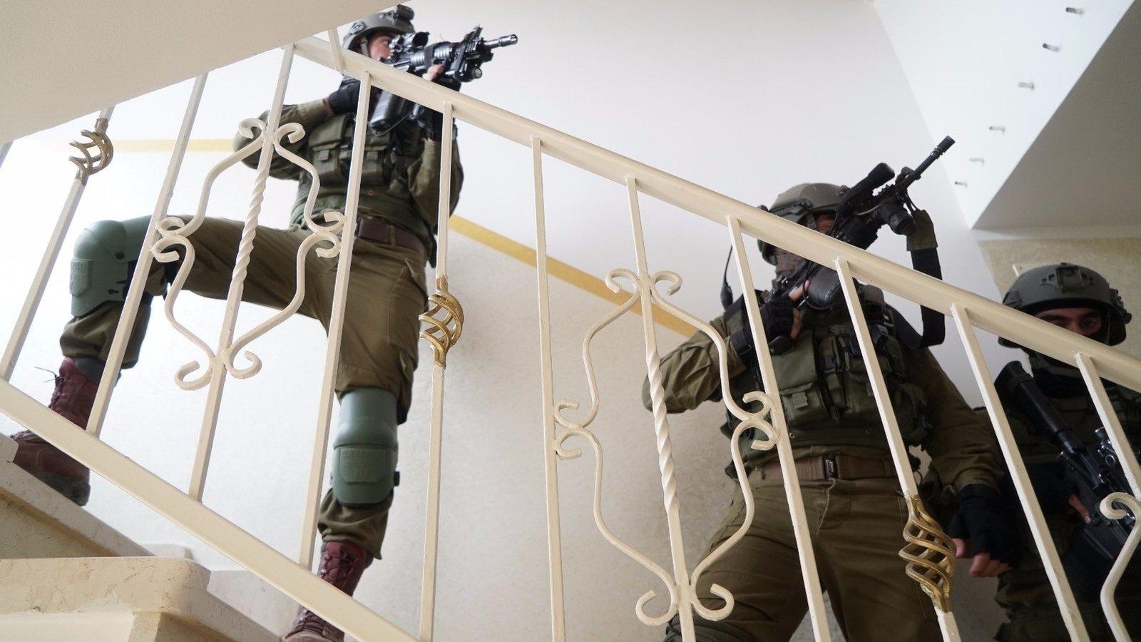 Handout from Israel Defense Forces showing troops searching for Palestinian man suspected of killing two Israelis at a factory in the occupied West Bank on 7 October 2018