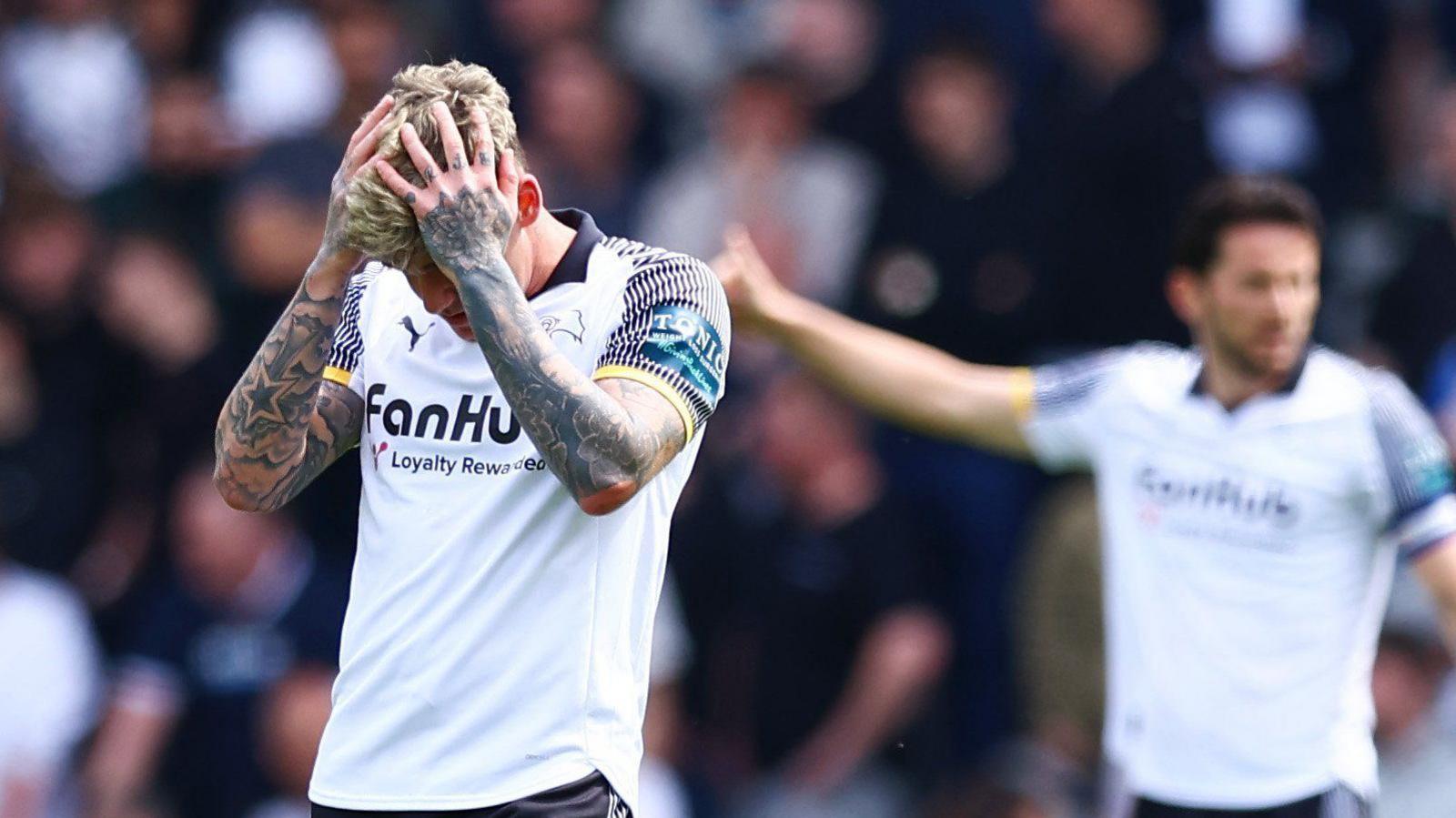 Derby County's Sam Szmodics has his hands in his head with despair 