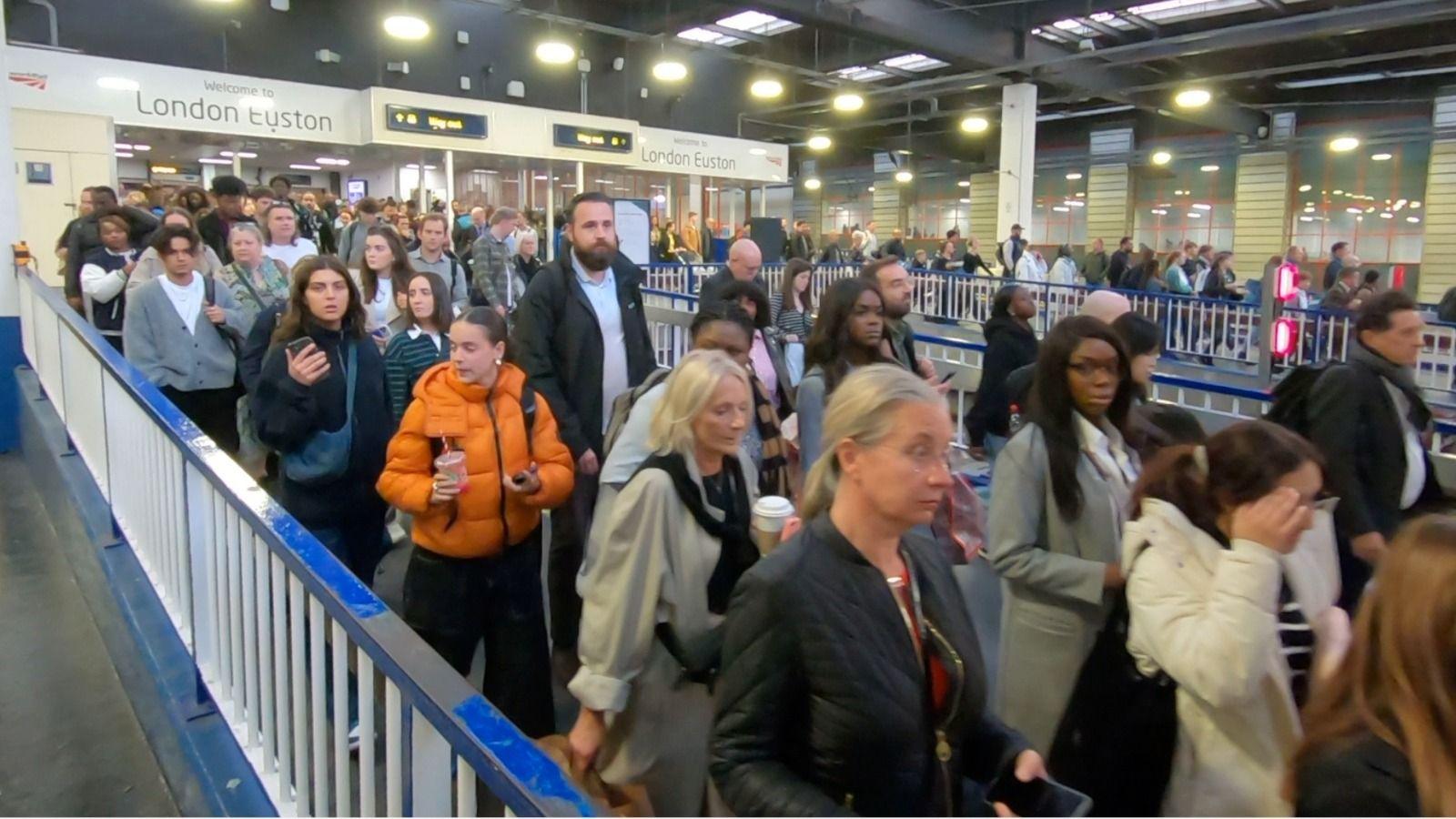 People moving down a ramp at Euston station