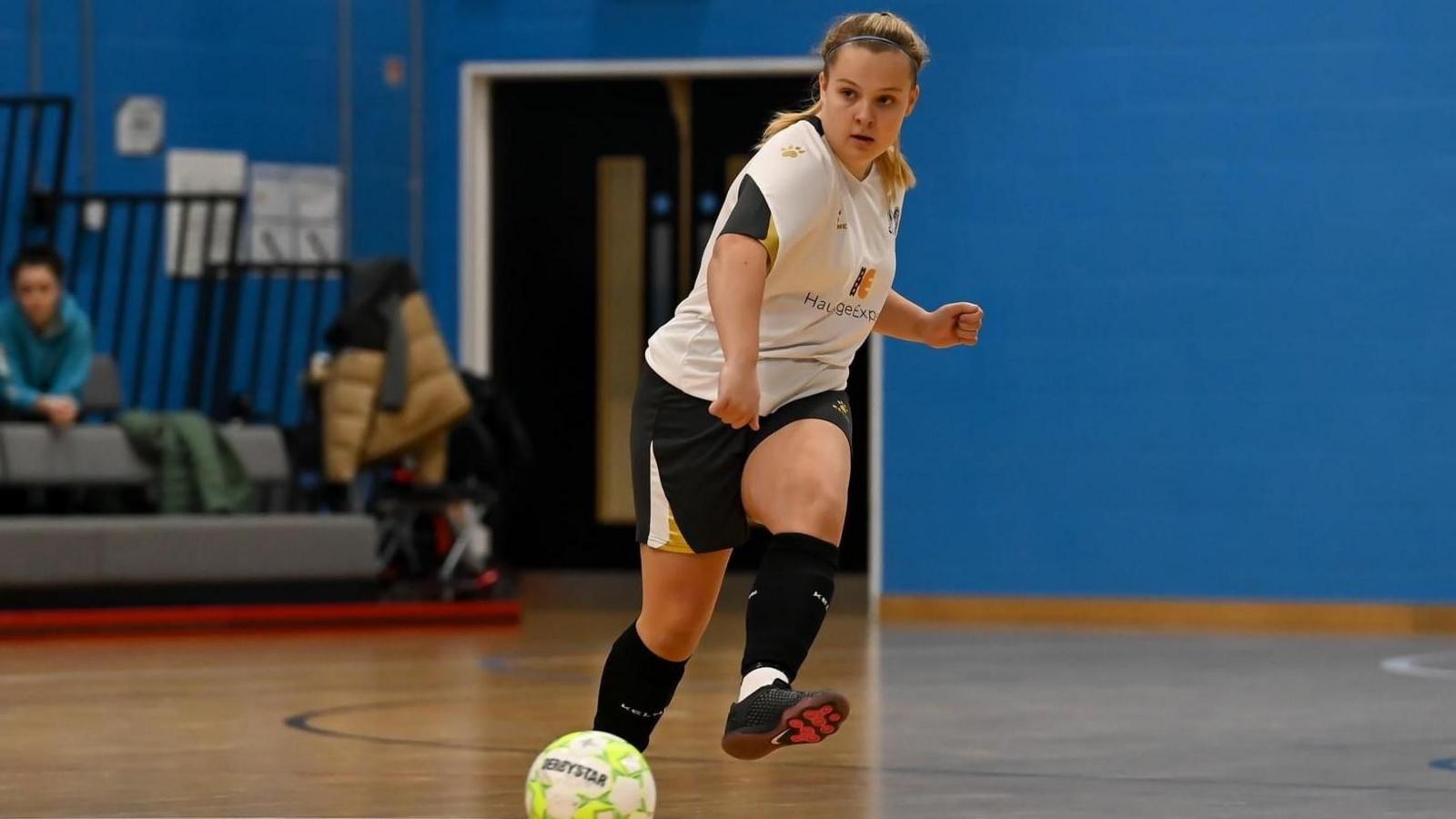 Ella Brennan kicks a ball