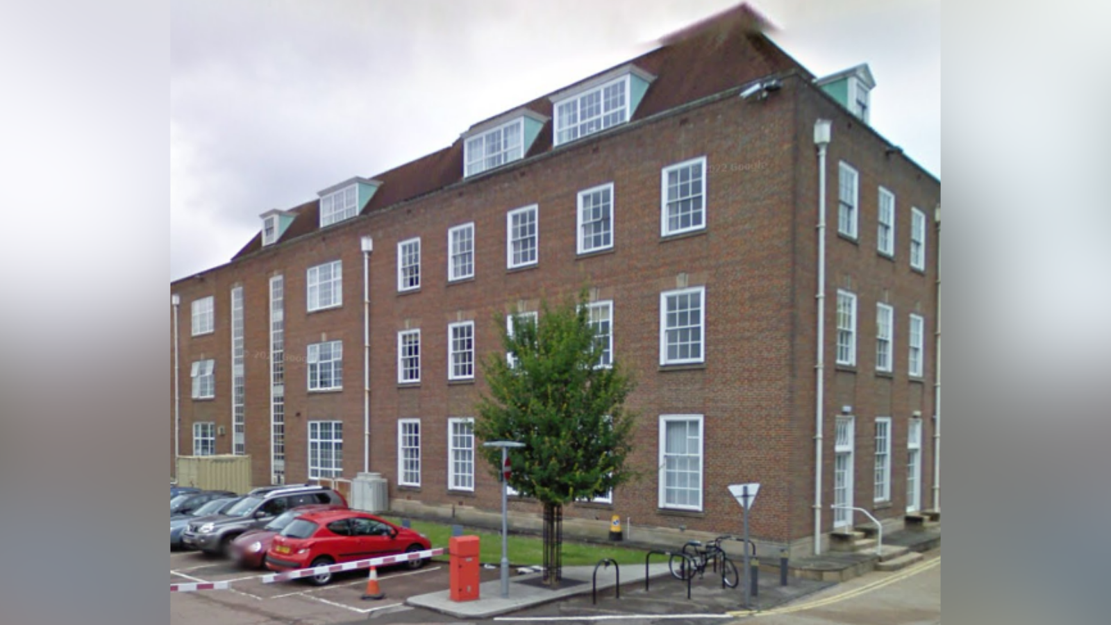 An exterior picture of the West Sussex County Council offices in Chichester. It is a four-floor red brick building. 