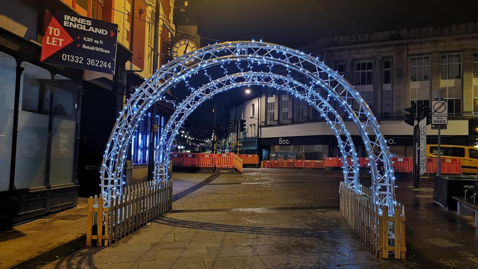 Two light up arch ways are lit up with light blue fairy lights