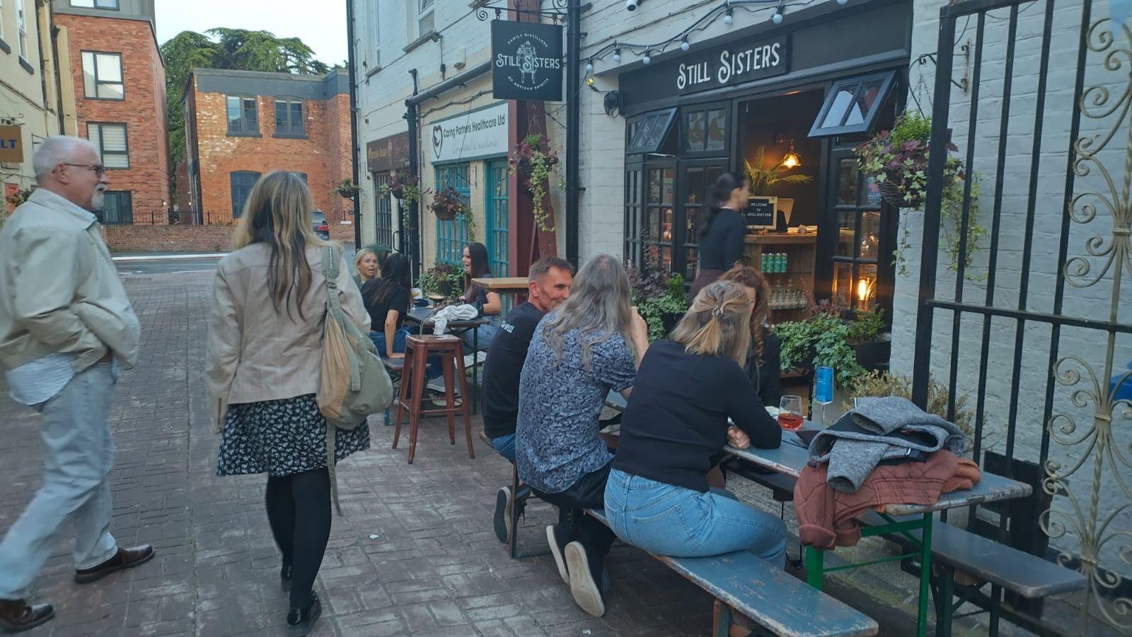 People enjoying nightlife outside a bar