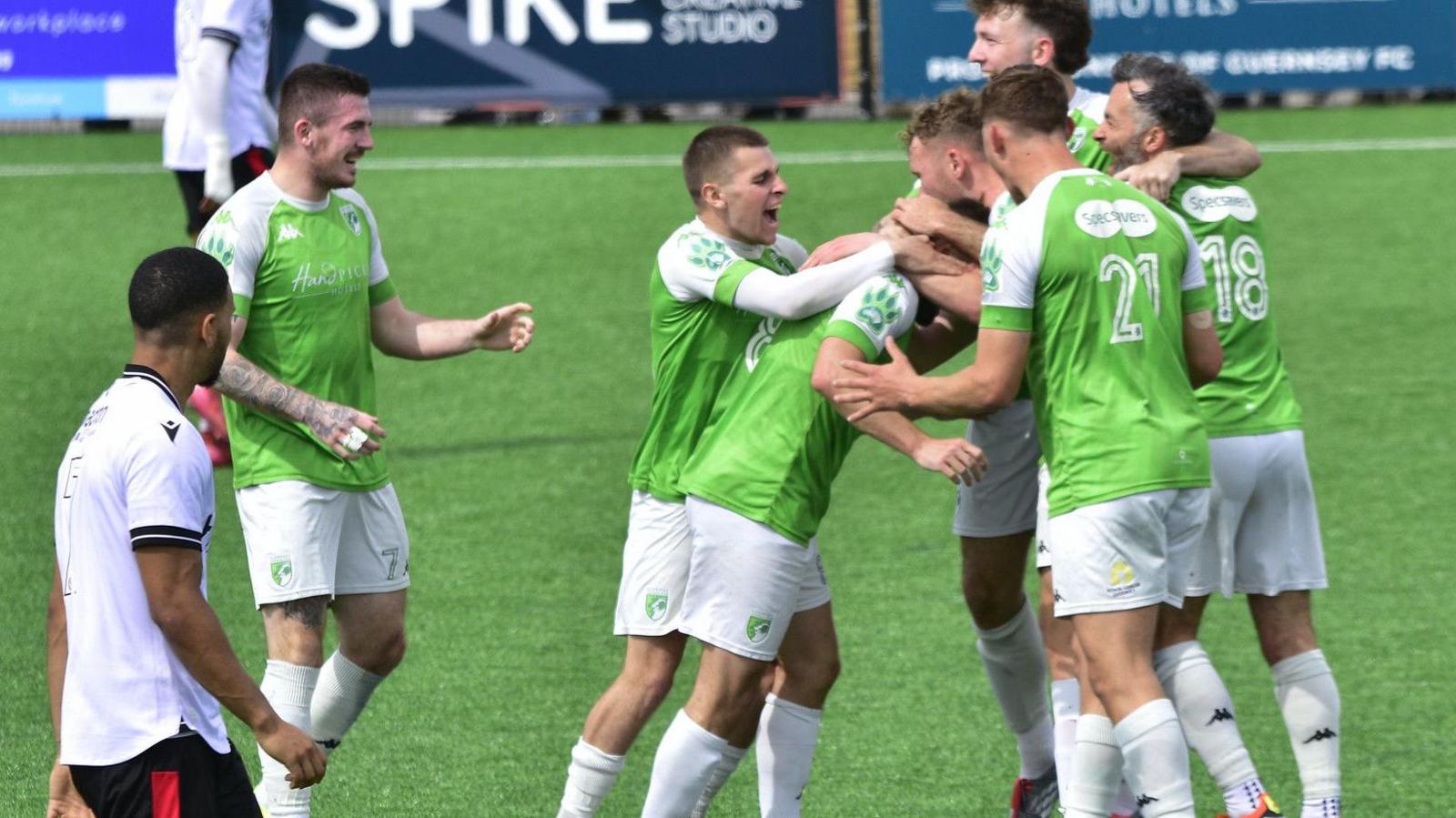 Guernsey FC's players celebrate a goal against Horsham YM