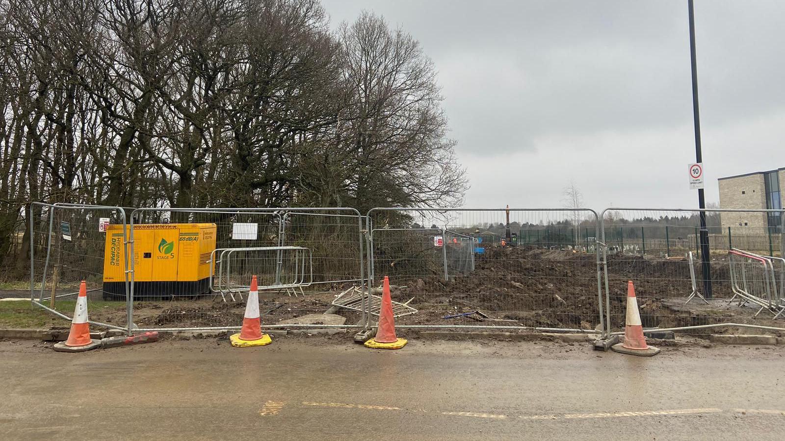 Construction site with orange cones and fencing