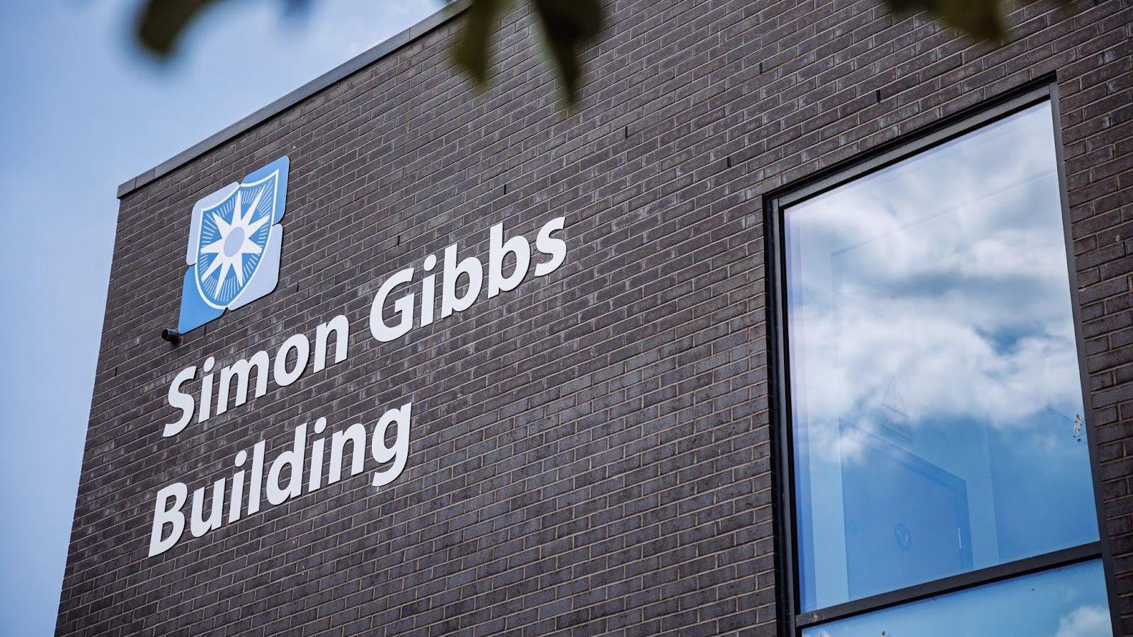 The corner of the block with Simon Gibbs Building written on it in big letters