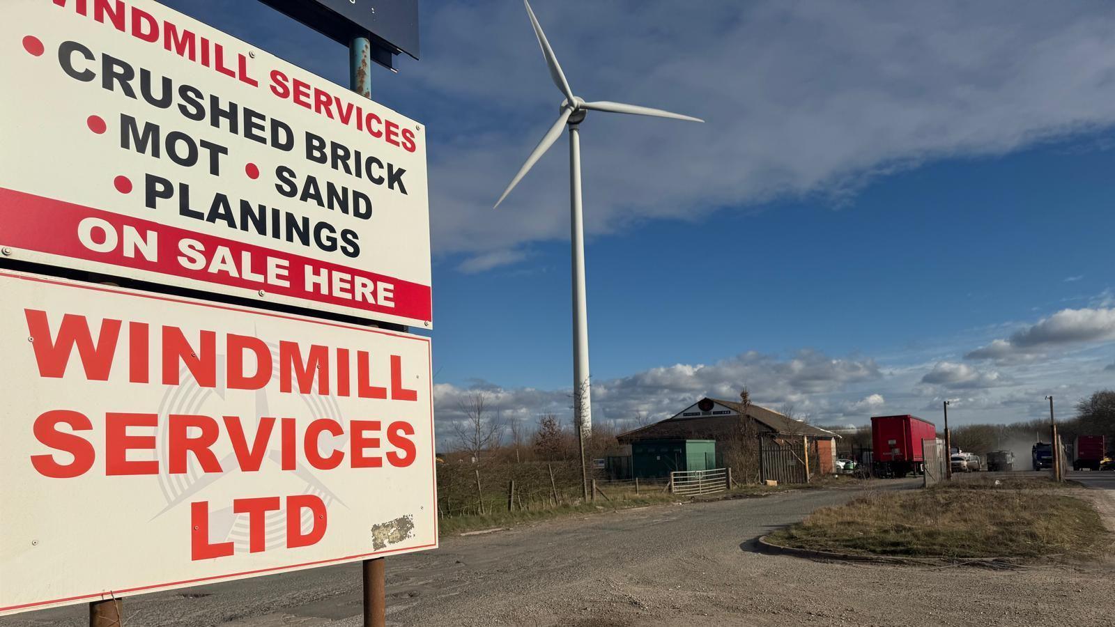 Sign with Windmill Services details in front of the site