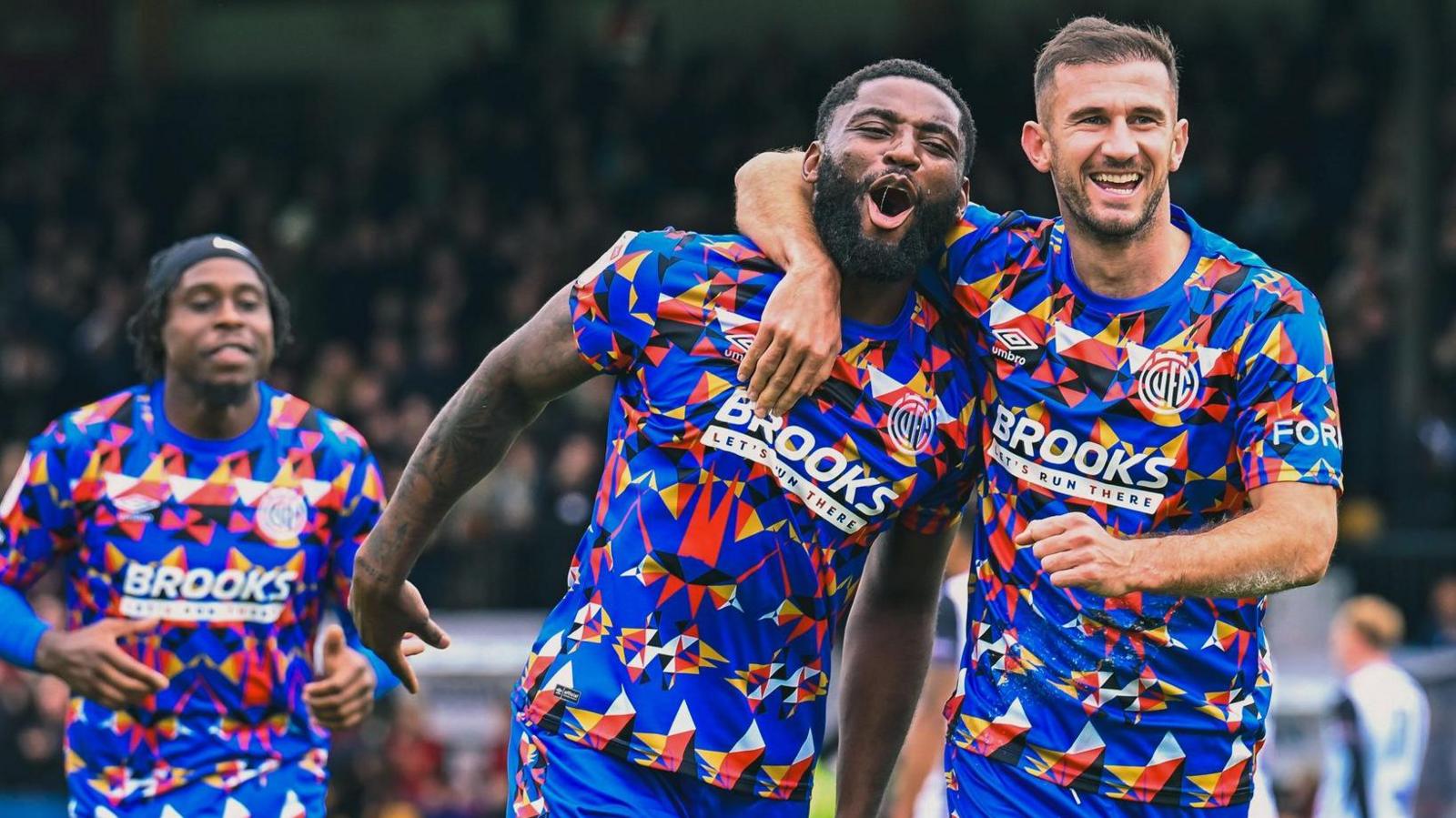 Kylian Kouassi celebrates after scoring for Cambridge