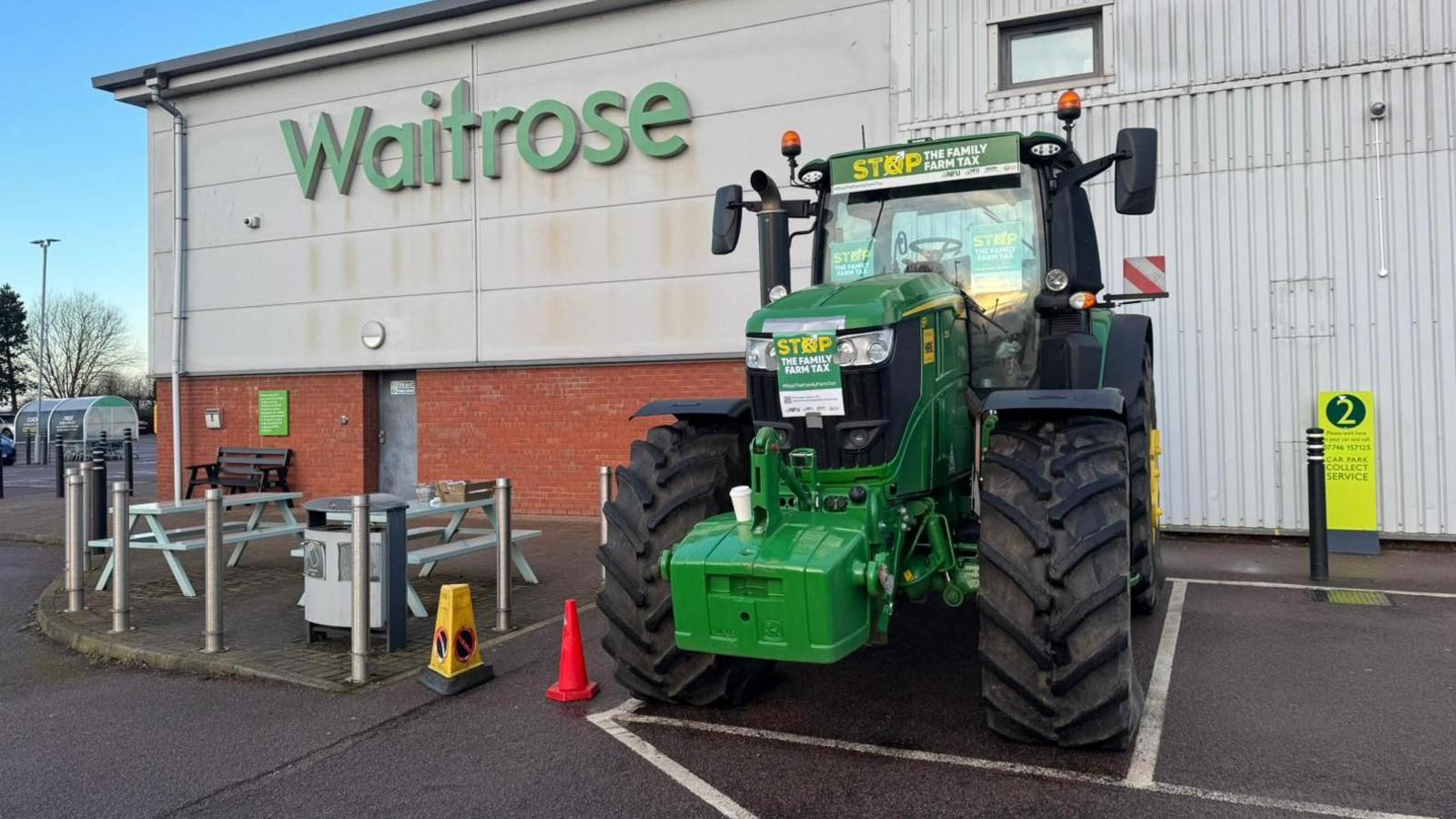 large green tractor parked in a supermarket bay