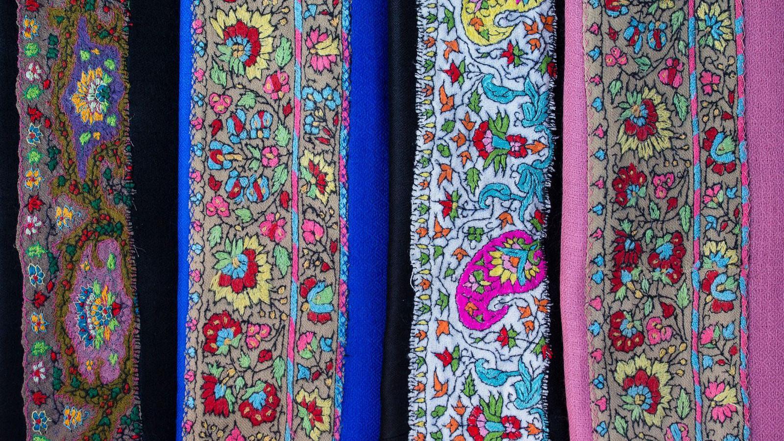 A stock picture of pashmina shawls displayed in different colours