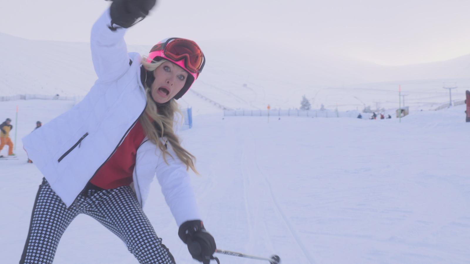 Actress Caprice is seen in stills from the movie skiing down the slopes of Aviemore and falling down while pulling a silly face.