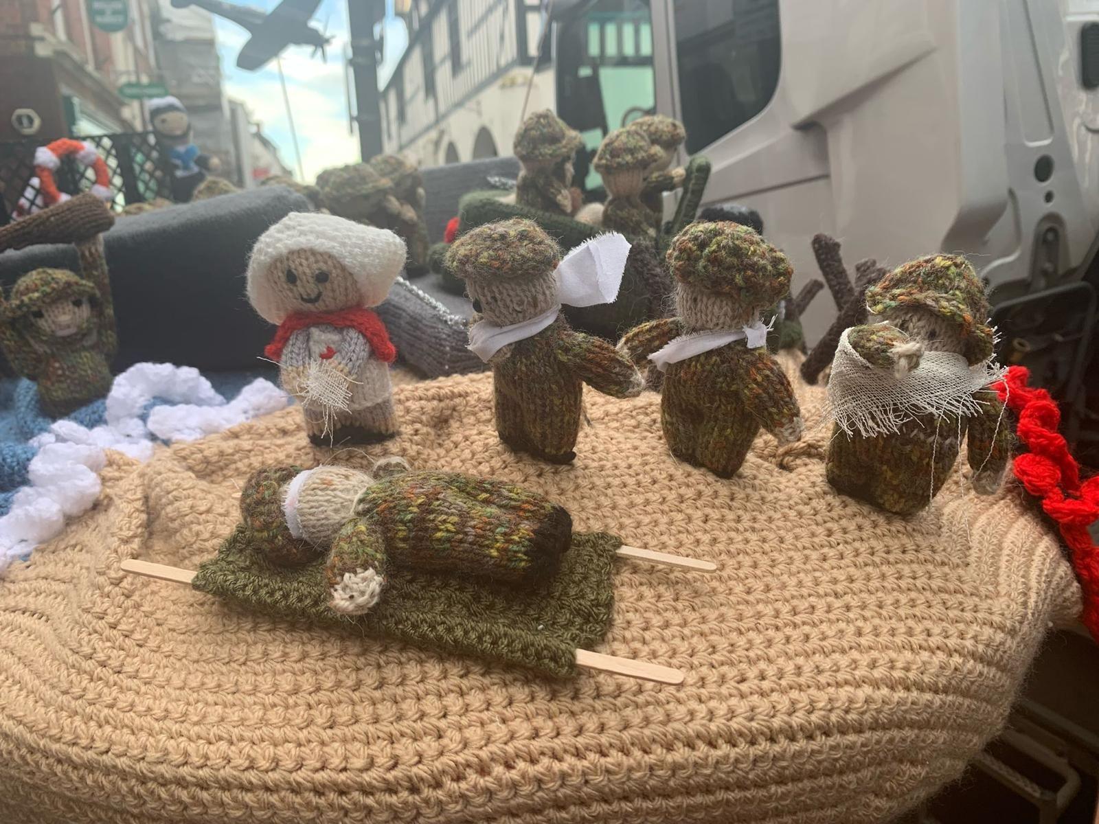 Knitted scenes from D-Day on top of a postbox