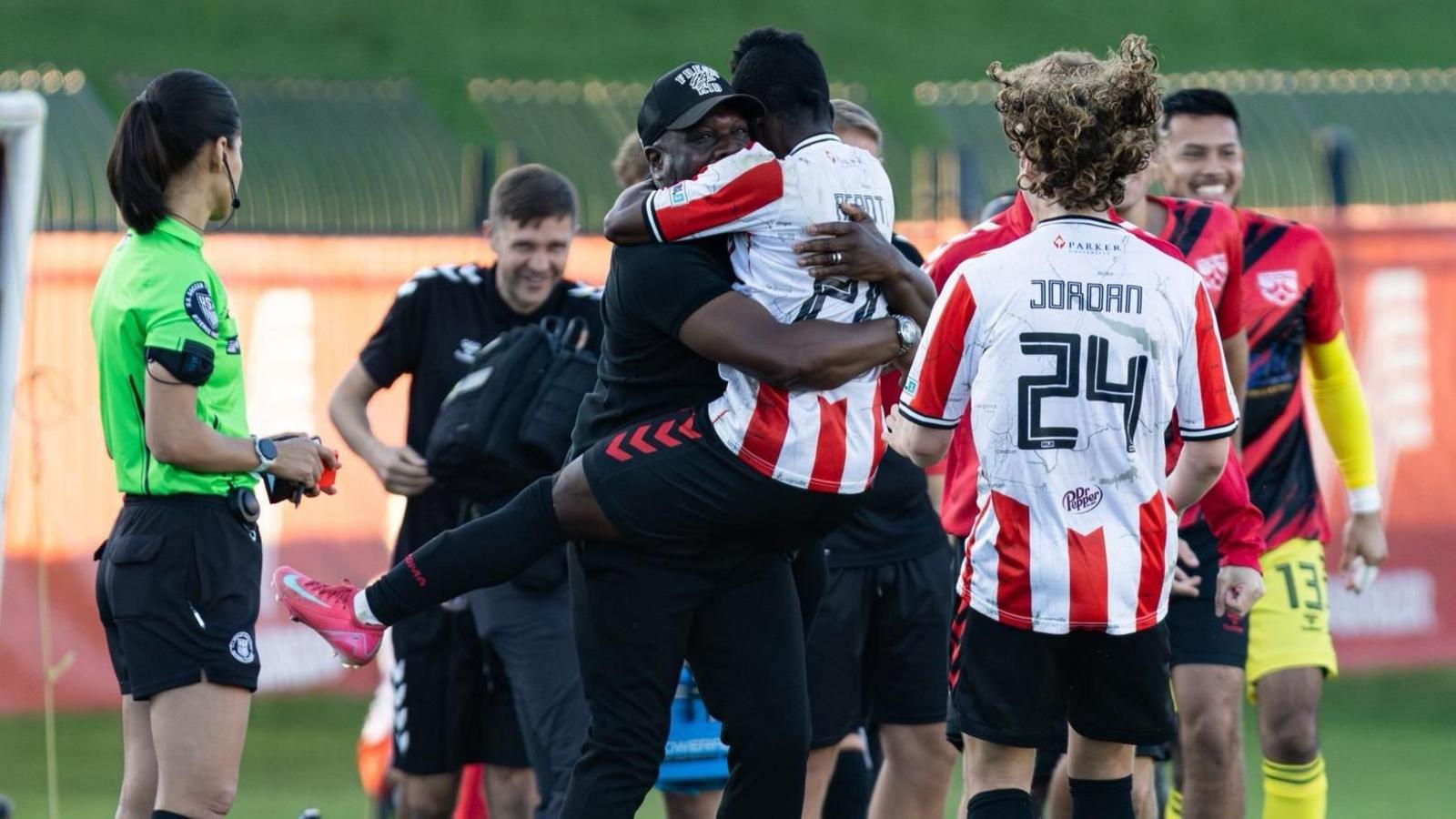 Adrian Forbes hugs a Texoma FC player