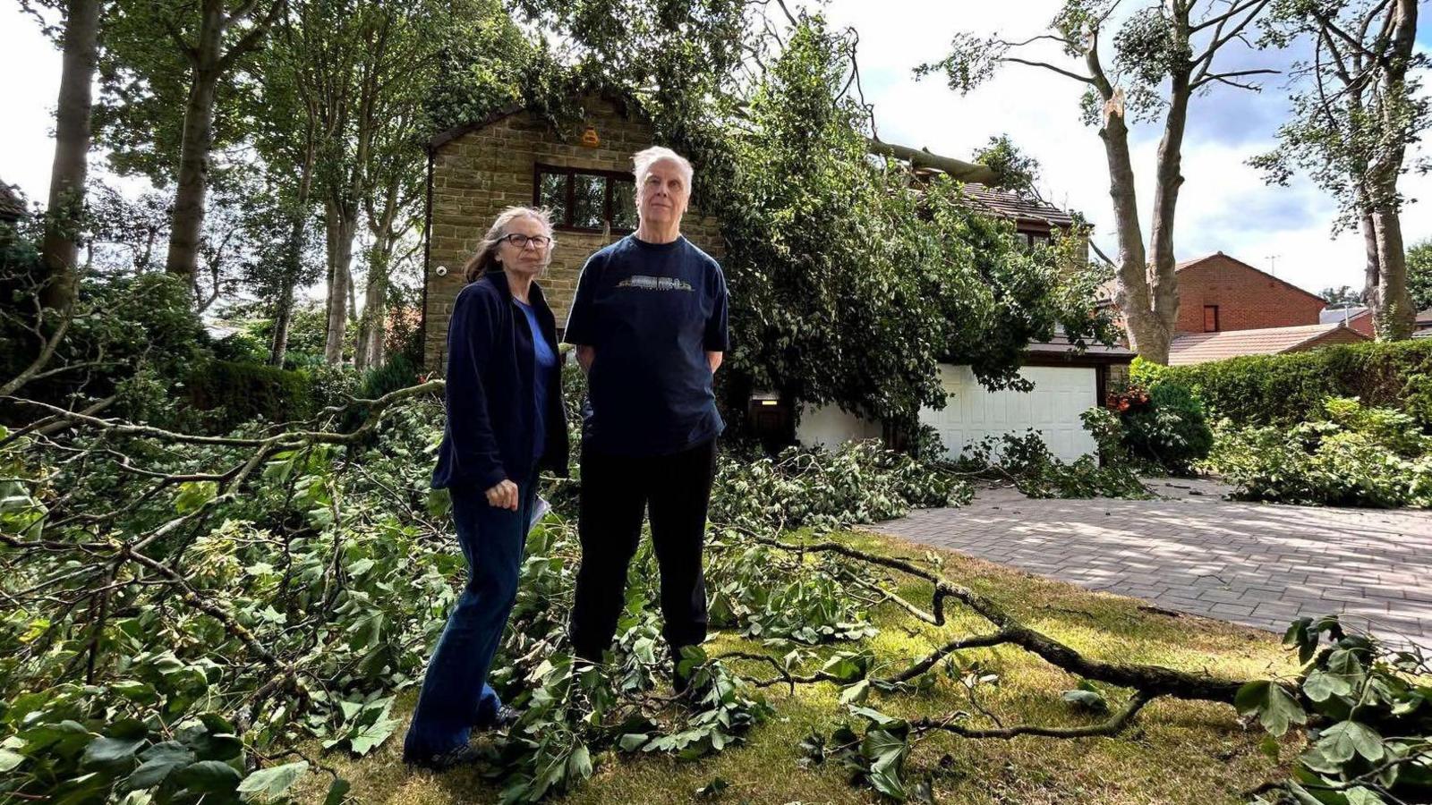 Mr and Mrs Booth standing outside their home