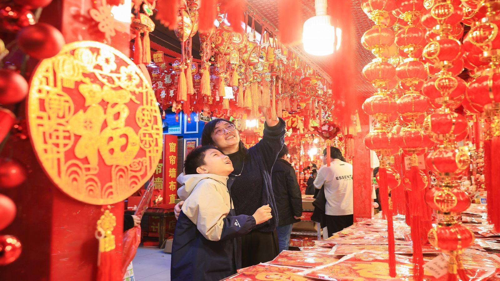 People shop for Spring Festival ornaments at a trade mall in Nanjing