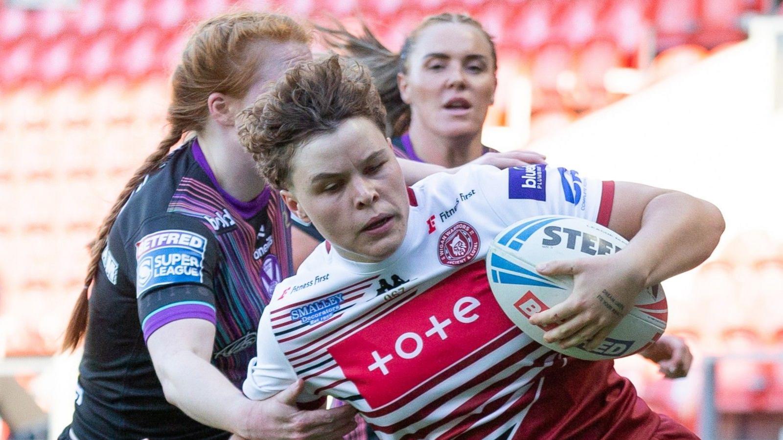 Molly Jones carries the ball for Wigan Warriors